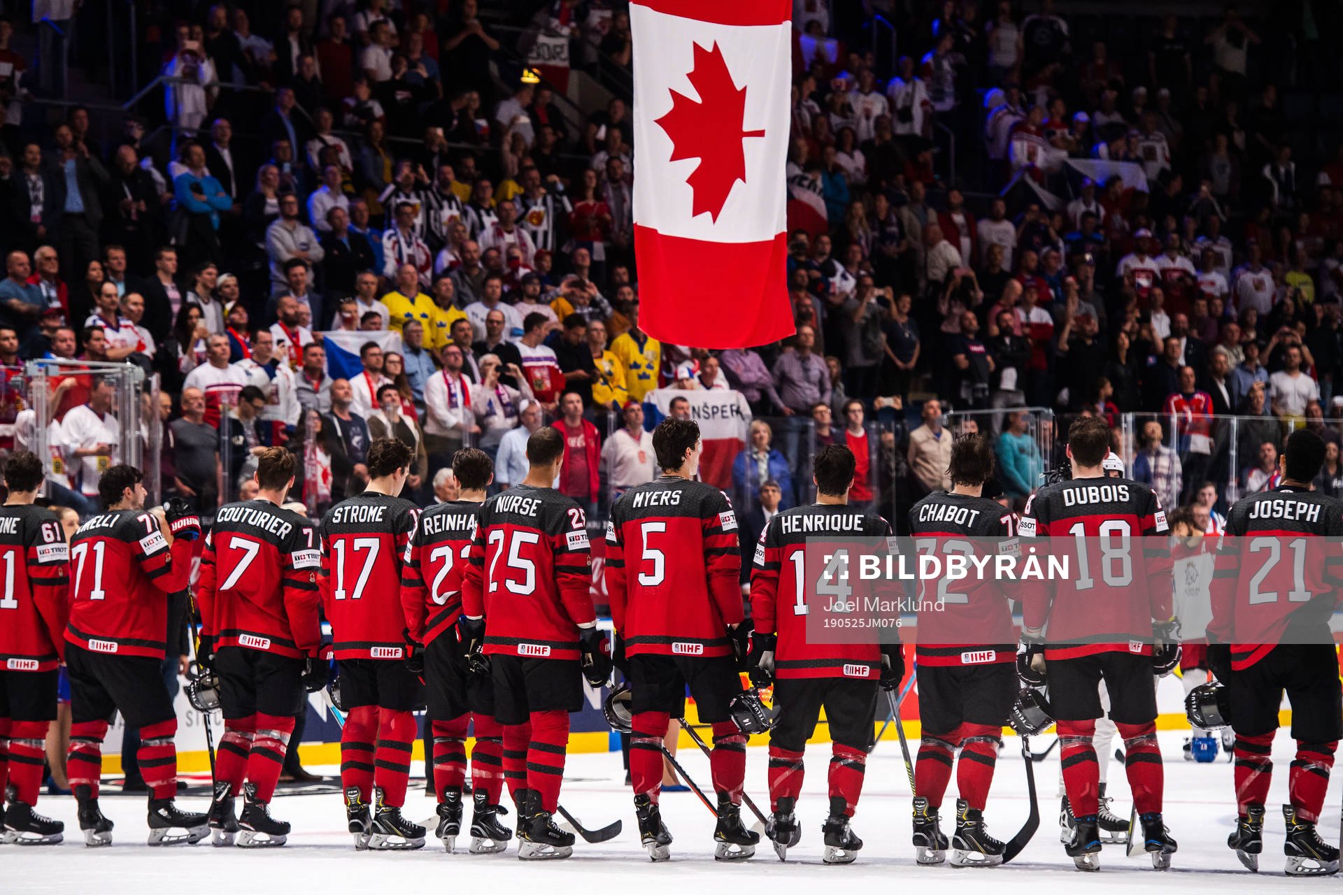 Players of Canada gathers in front of the Canadian flag