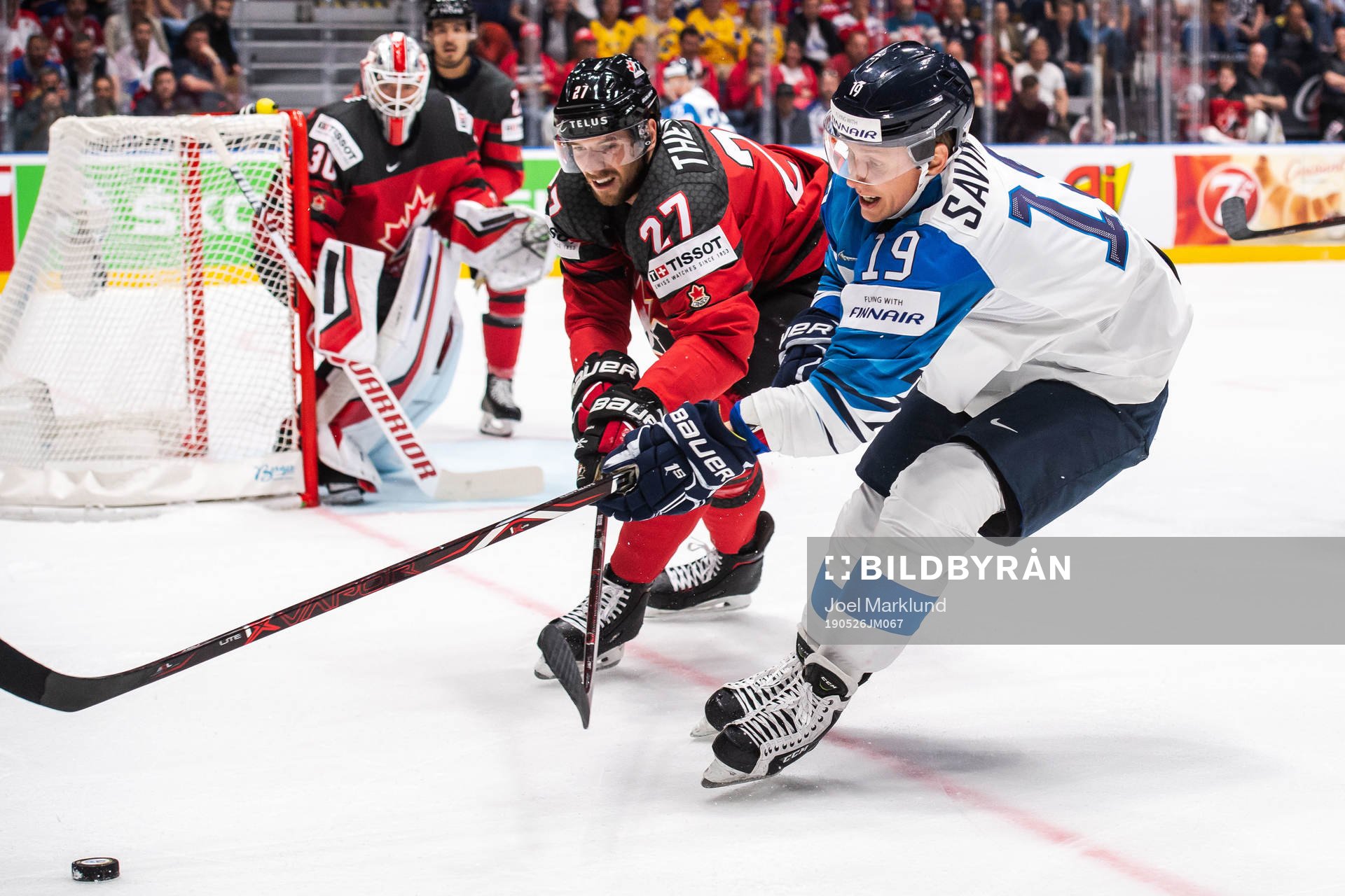 Shea Theodore of Canada and Veli-Matti Savinainen of Finland