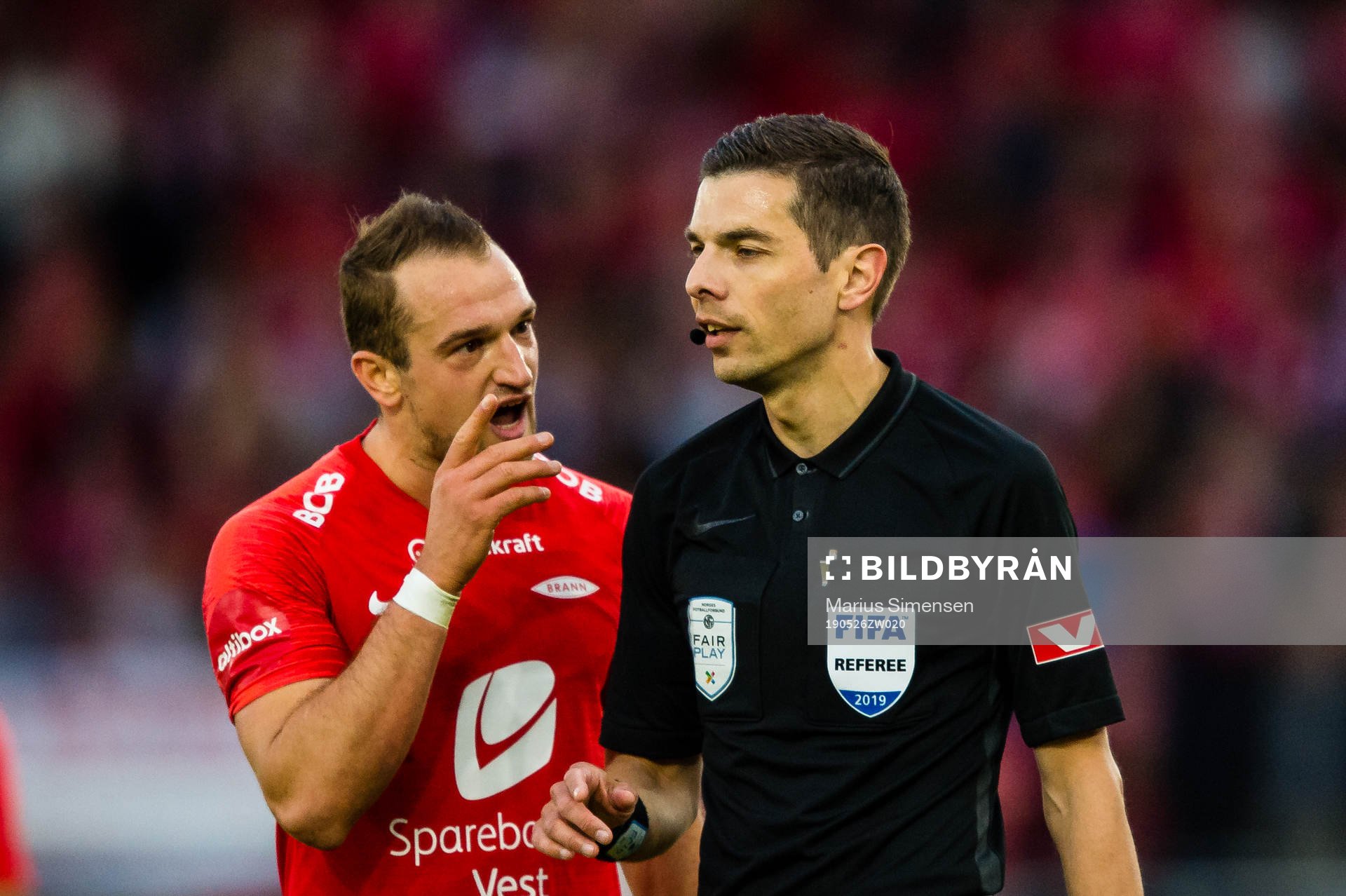 Veton Berisha of Brann and Tore Hansen, referee