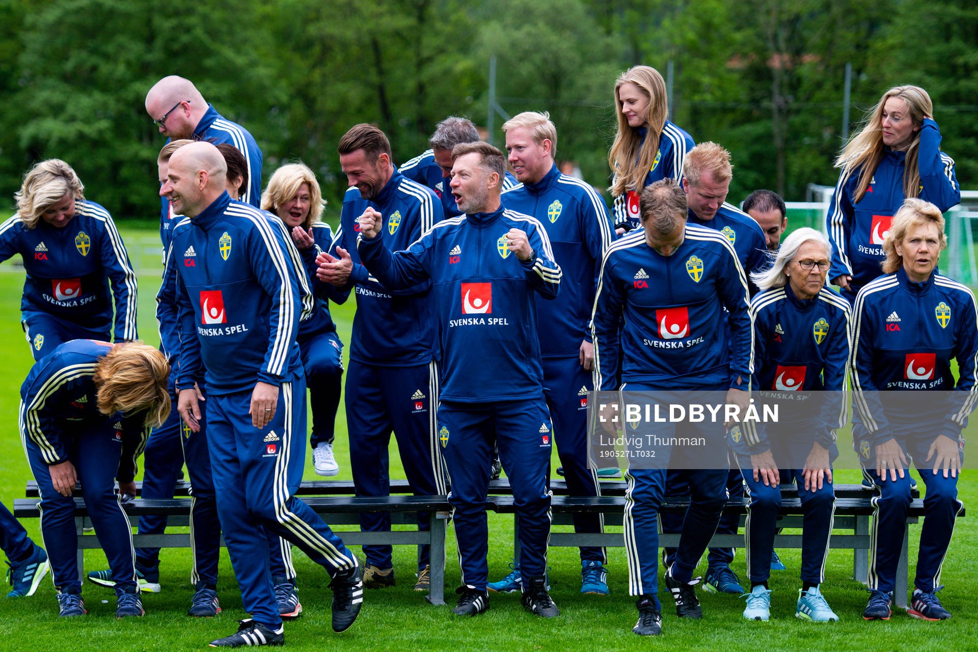 Staff leave a team photo shoot with coaching staff of the