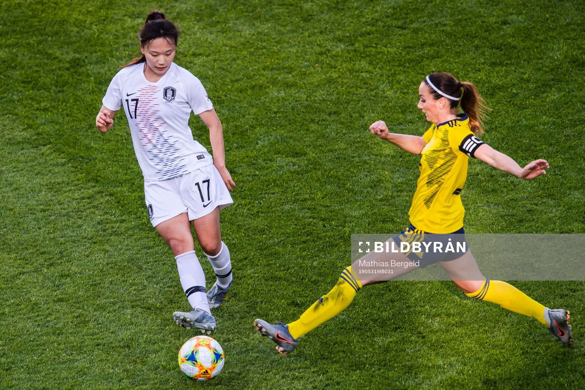 Geummin Lee of South Korea and Kosovare Asllani  of Sweden