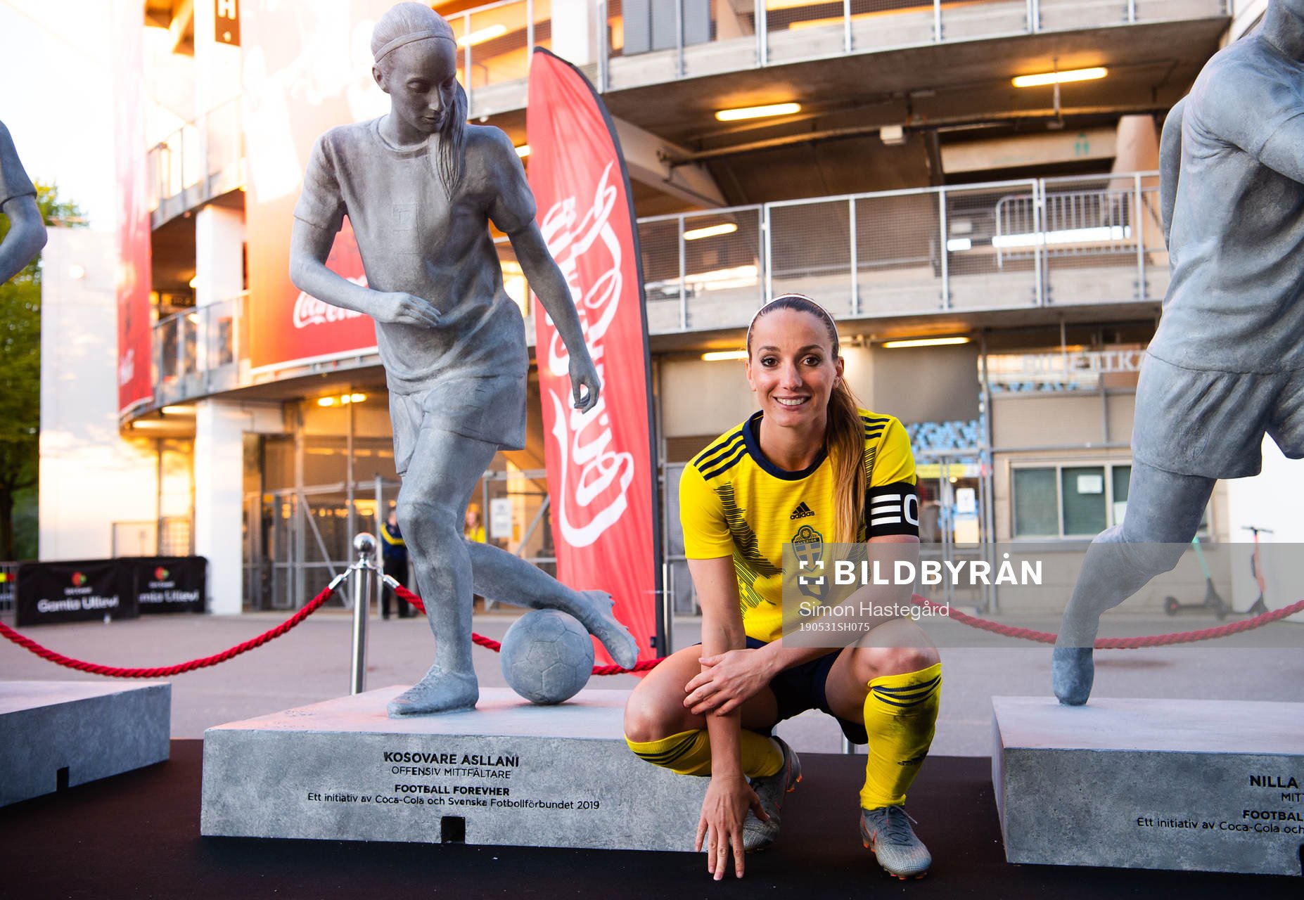 Kosovare Asllani of Sweden next to a statue of herself