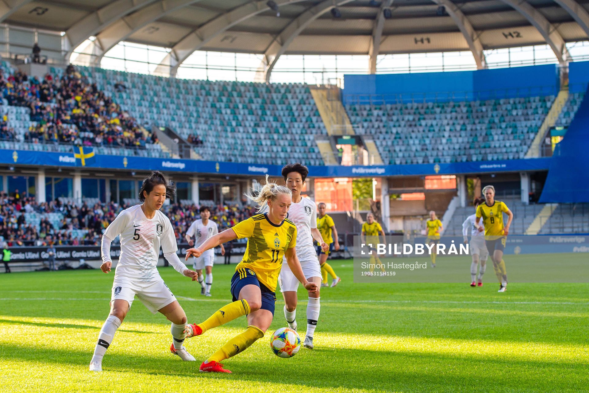 Doyeon Kim of South Korea   and Stina Blackstenius of Sweden