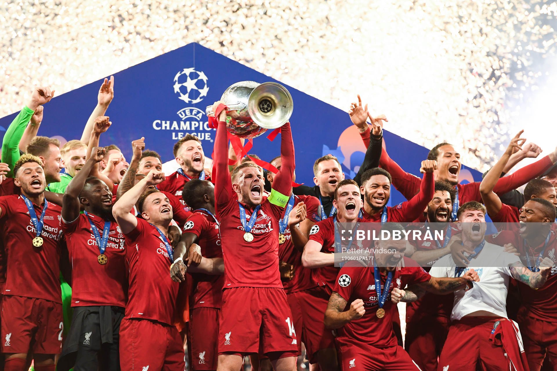 Jordan Henderson of Liverpool raises the throphy in front of team mates at the medal ceremony after the UEFA Champions League final between Tottenham and Liverpool on June 1, 2019 in Madrid.