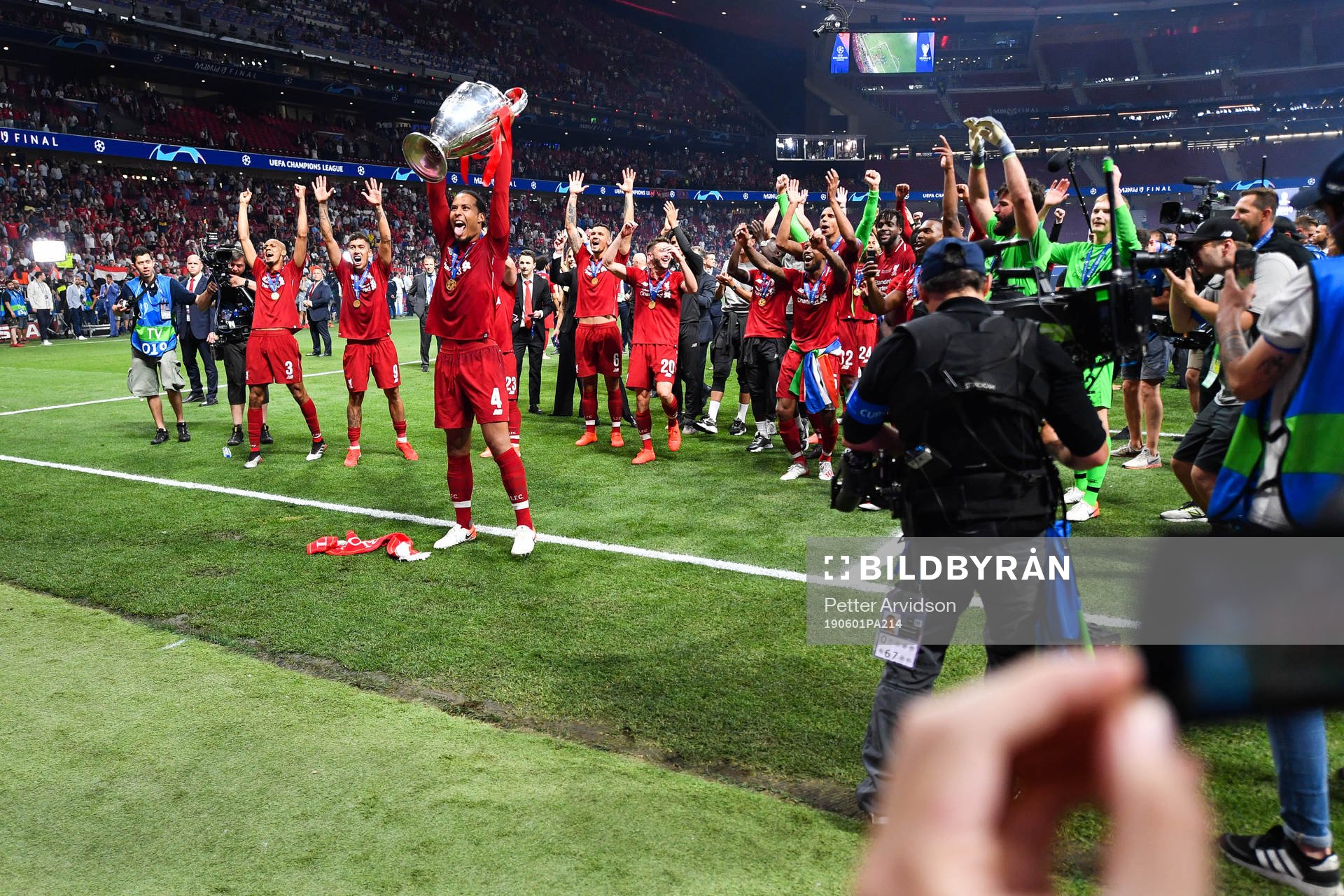 Virgil van Dijk of Liverpool celebrate with the trophy