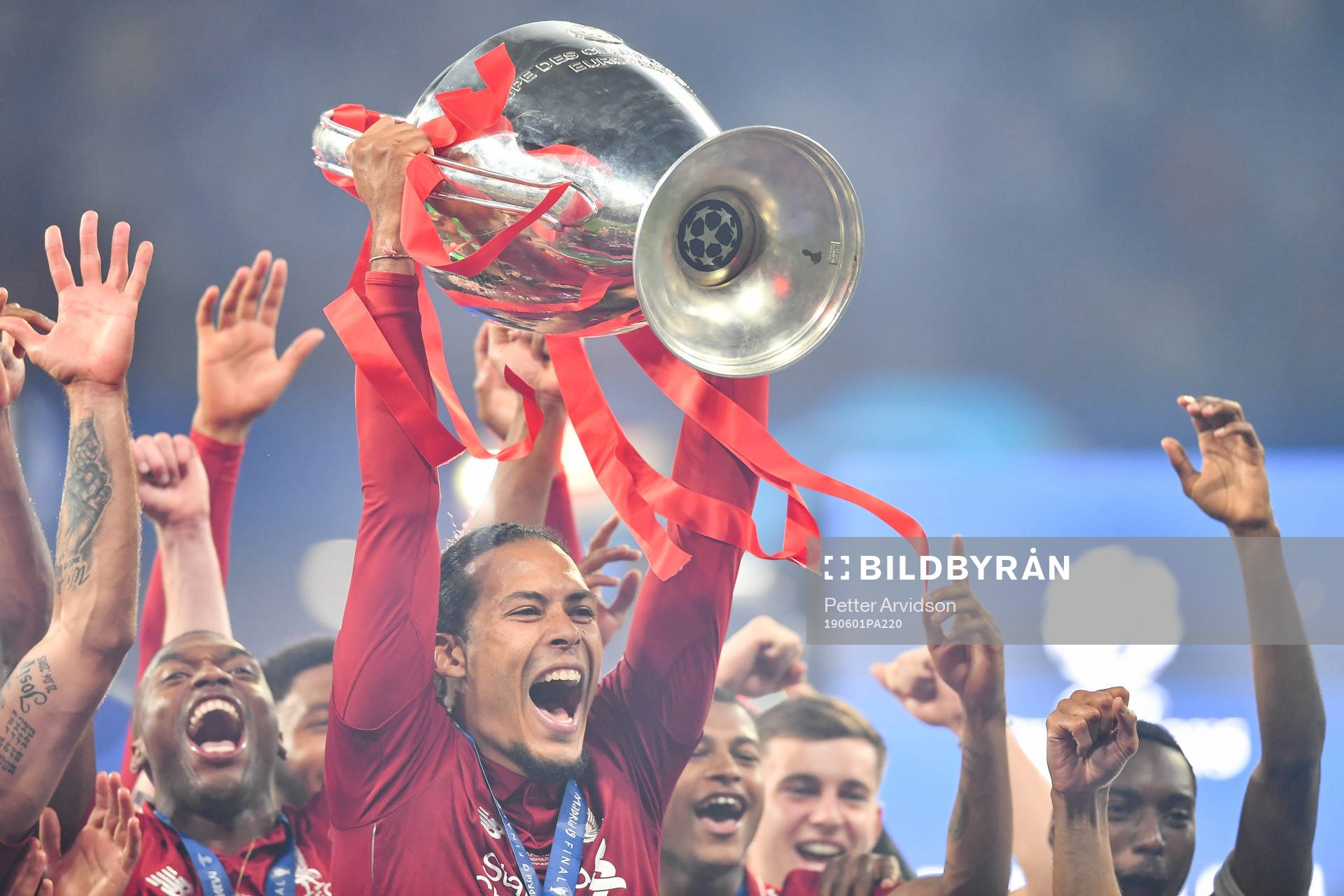 Virgil van Dijk of Liverpool celebrate with the trophy