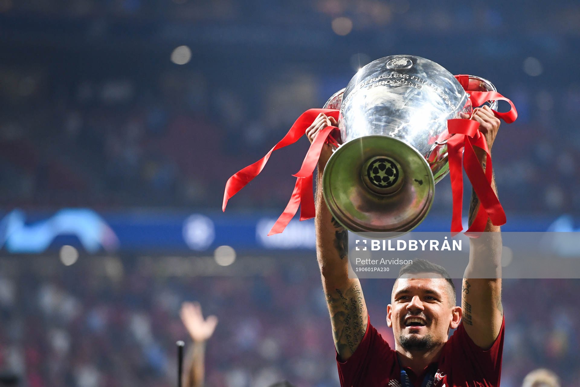 Dejan Lovren of Liverpool celebrate with the trophy