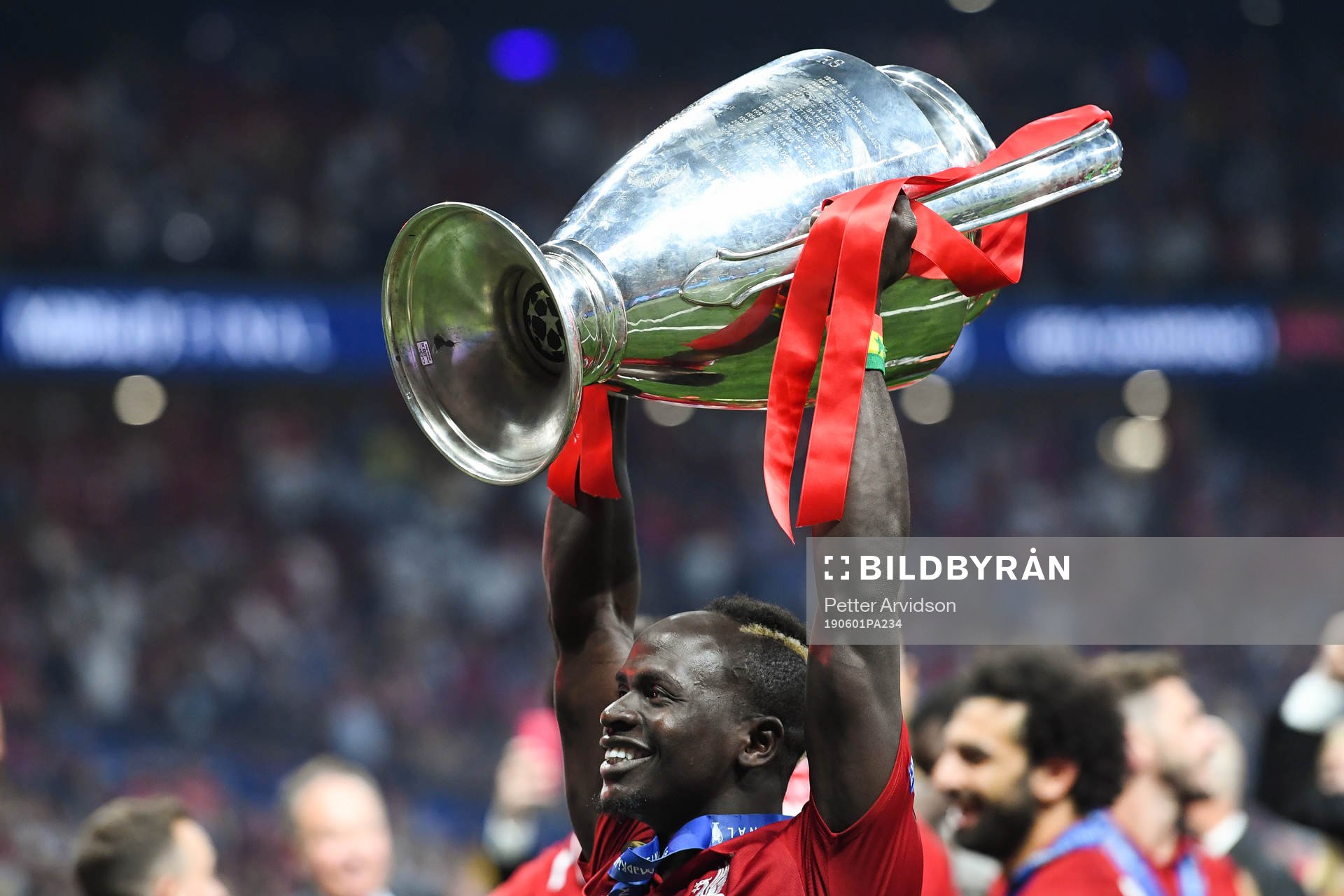 Sadio Mane of Liverpool celebrates with the trophy after the UEFA Champions League final between Tottenham and Liverpool on June 1, 2019 in Madrid.