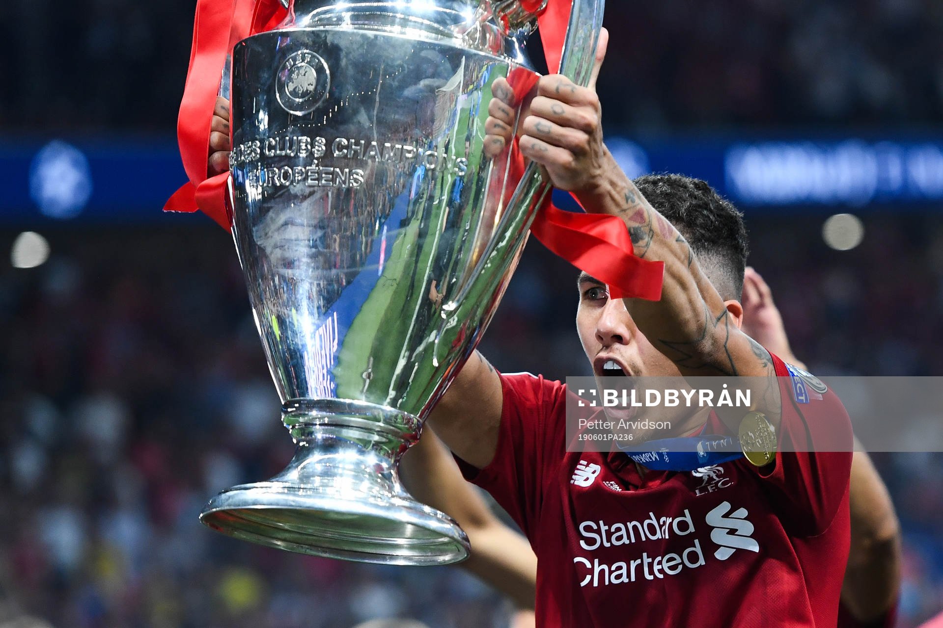 Roberto Firmino of Liverpool celebrates with the trophy