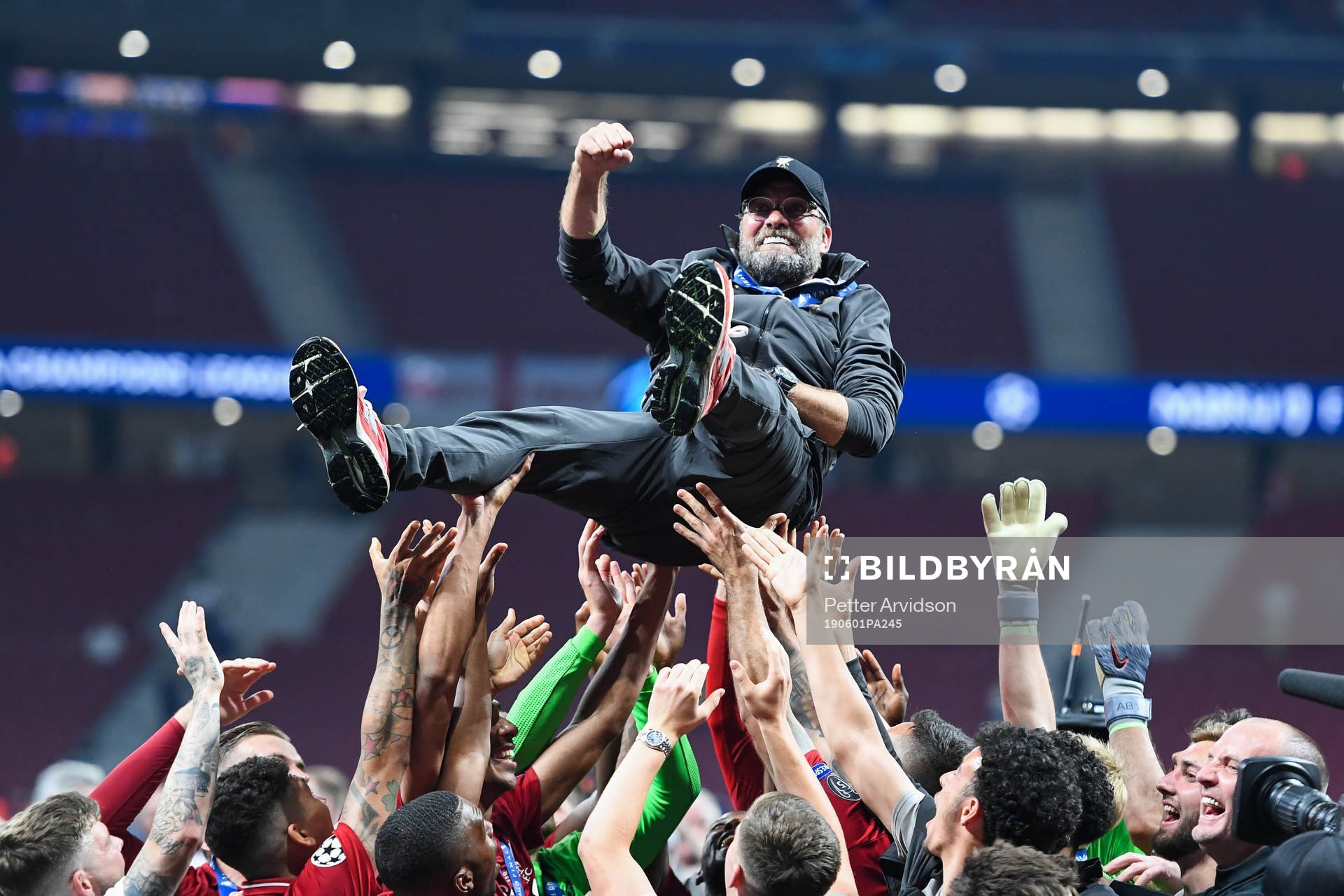 Head coach Jürgen Klopp of Liverpool is hoisted by the
