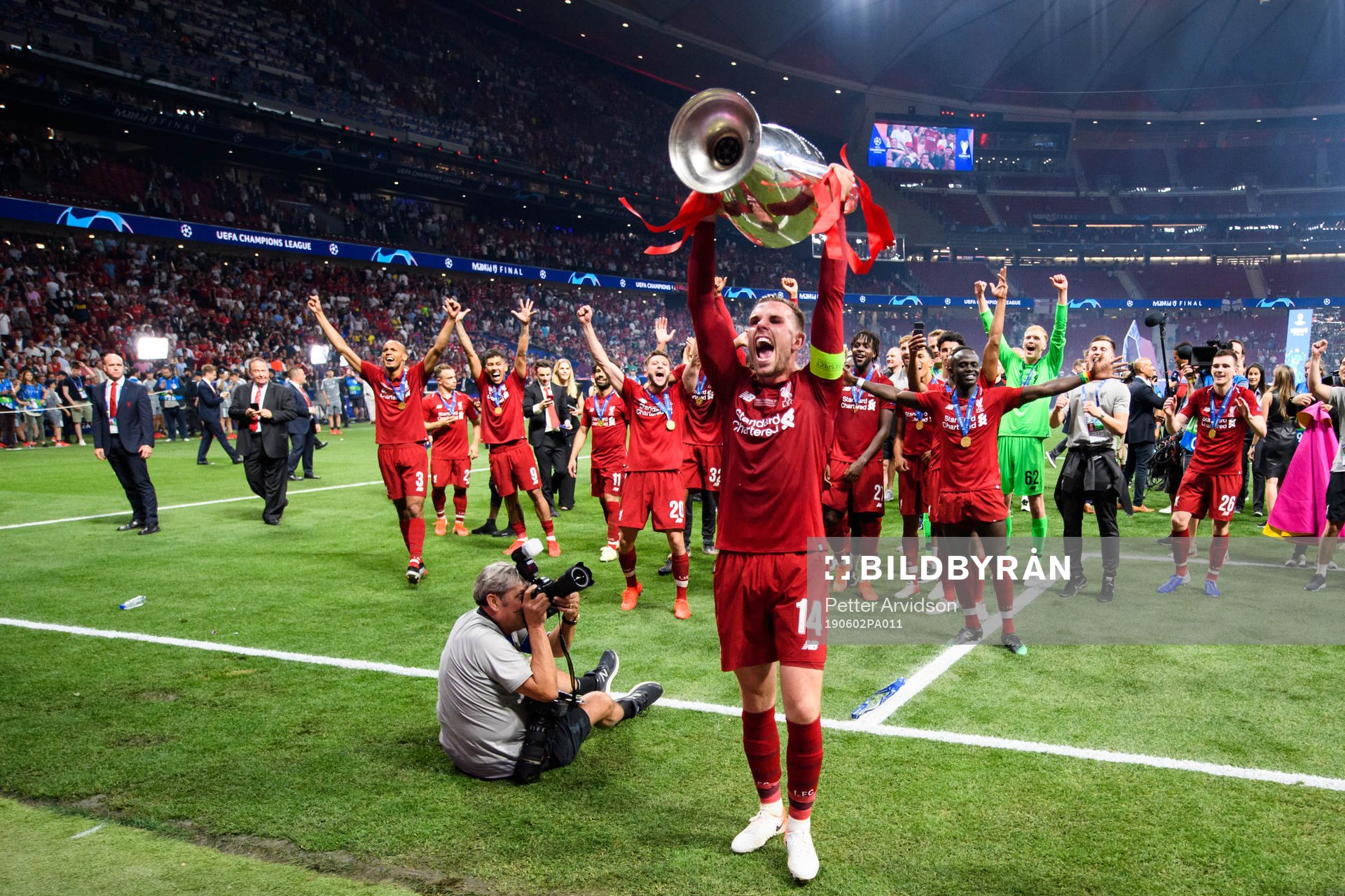 Jordan Henderson of Liverpool celebrates with the throphy
