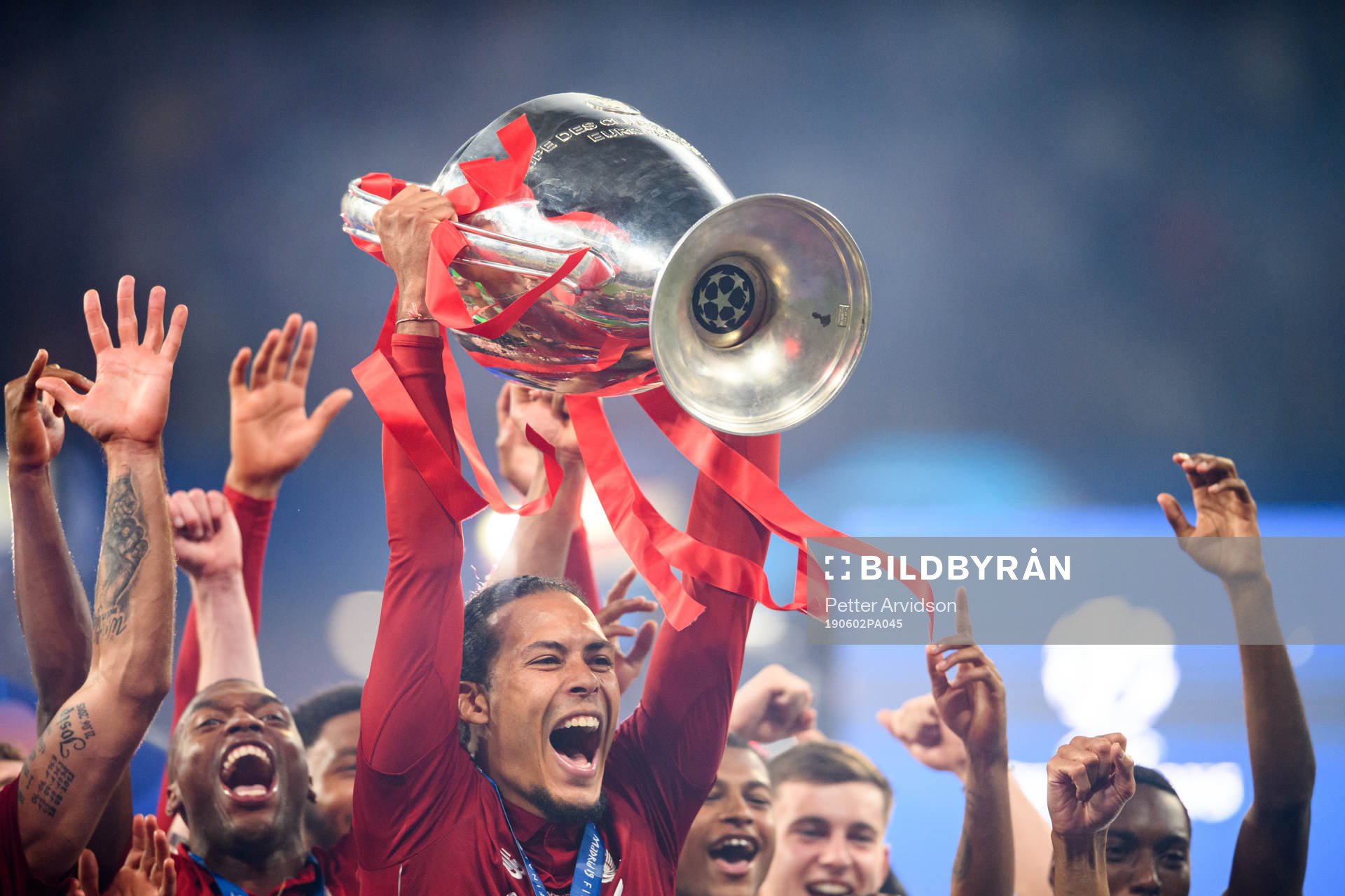 Virgil van Dijk of Liverpool celebrate with the trophy