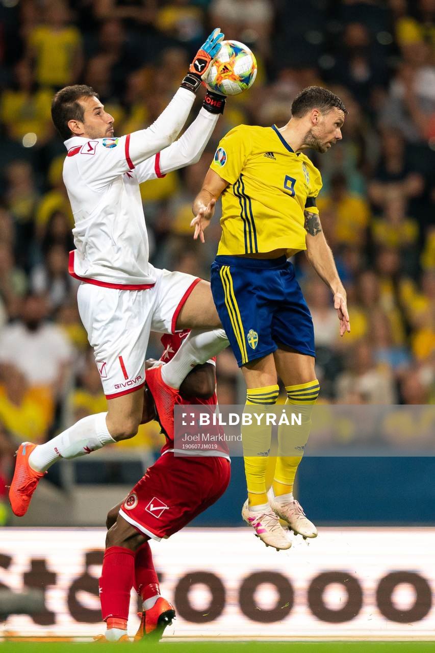 Goalkeeper Henry Bonello of Malta and Marcus Berg of Sweden