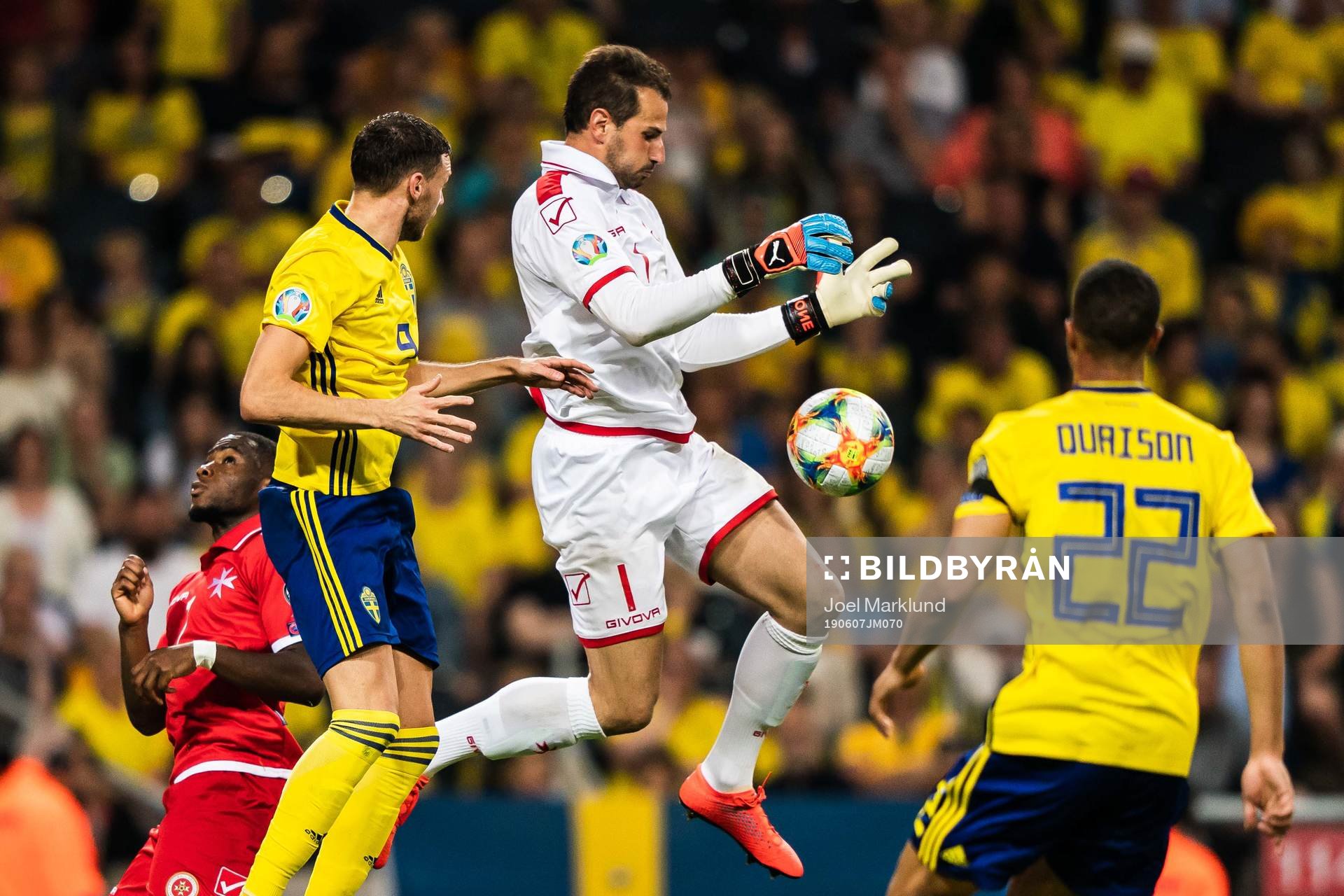 Marcus Berg and Robin Quaison against goalkeeper Henry