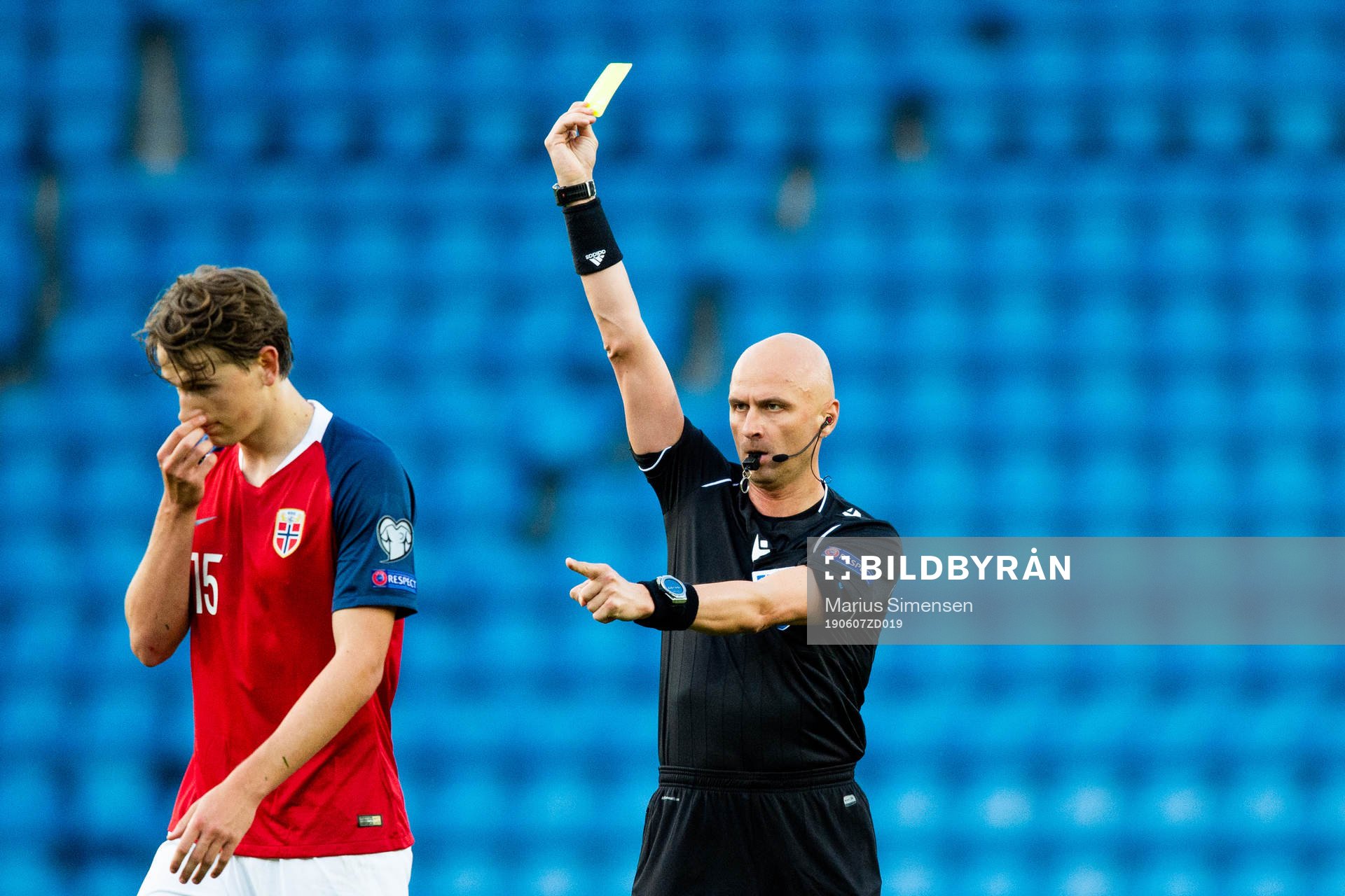 Sander Berge of Norway is shown a yellow card by Sergei
