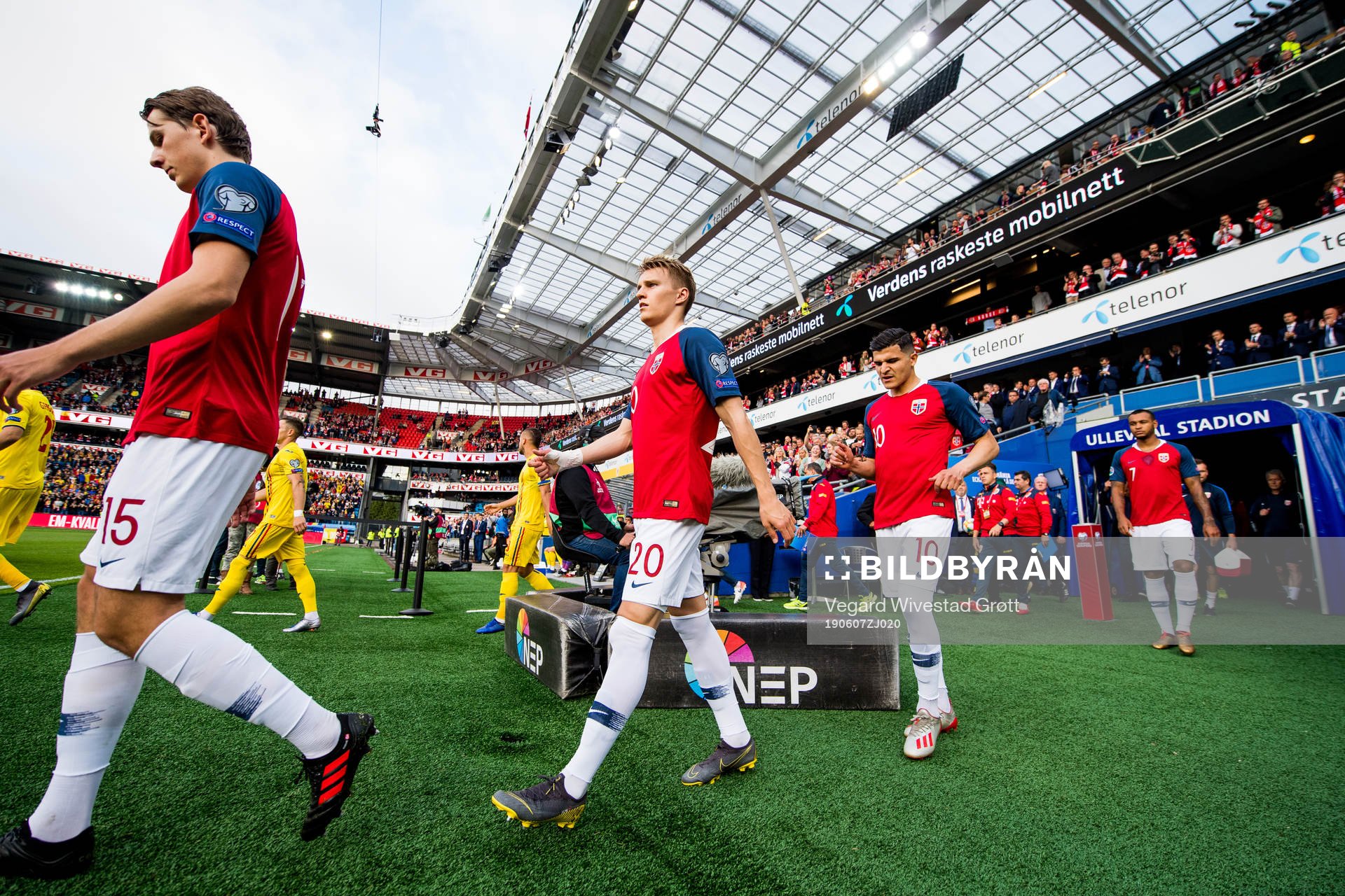 Martin Ødegaard and Tarik Elyounoussi of Norway enter the