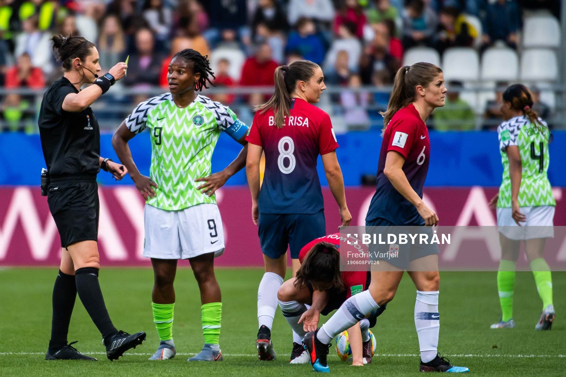 Desire Oparanozie of Nigeria is shown a yellow card