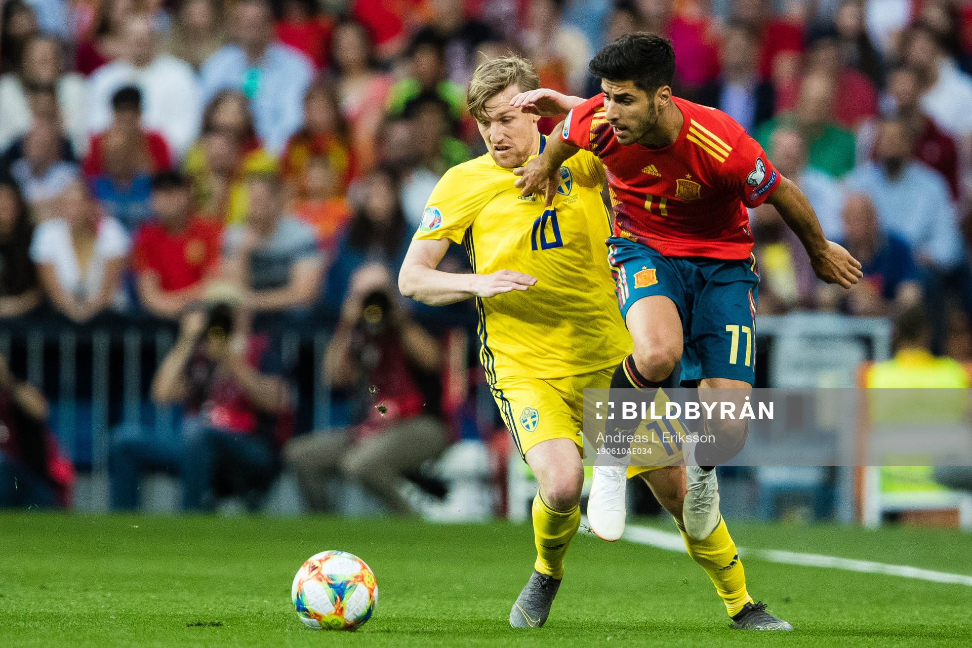 Emil Forsberg of Sweden and Marco Asensio of Spain competes