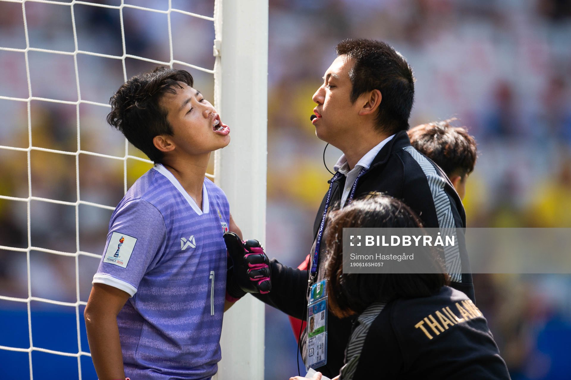 Goalkeeper Waraporn Boonsing of Thailand is attended to