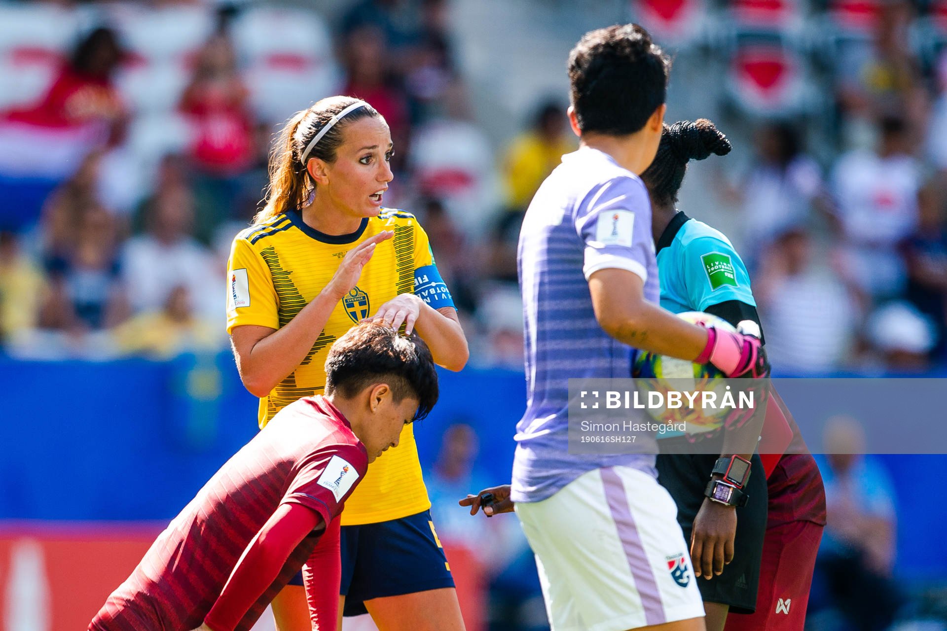Kosovare Asllani of Sweden talks to the referee