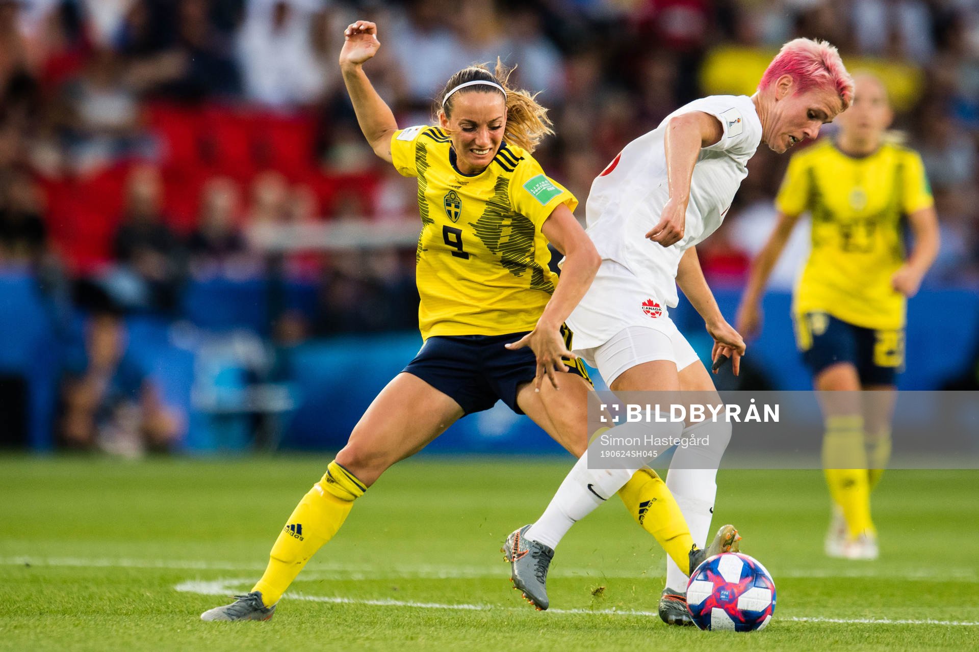 Kosovare Asllani of Sweden and Sophie Schmidt of Canada