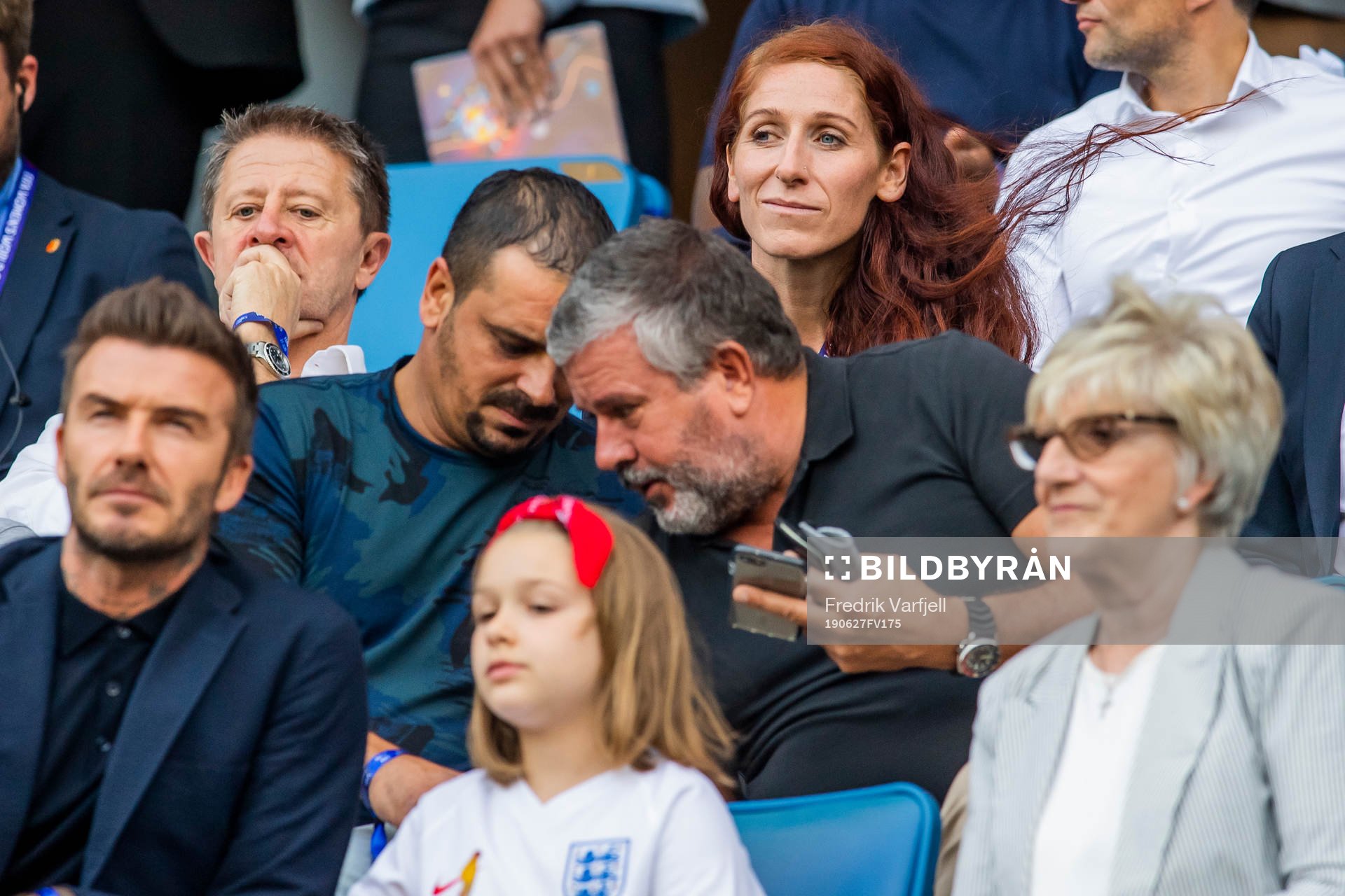Lise Klaveness, head of elite football at the Norwegian Football Association (NFF), behind former football player David Beckham with his daughter Harper and mother Sandra Georgina West in the stands ahead of the FIFA Women's World Cup Quarter Final match between Norway and England on June 27, 2019 in Le Havre.