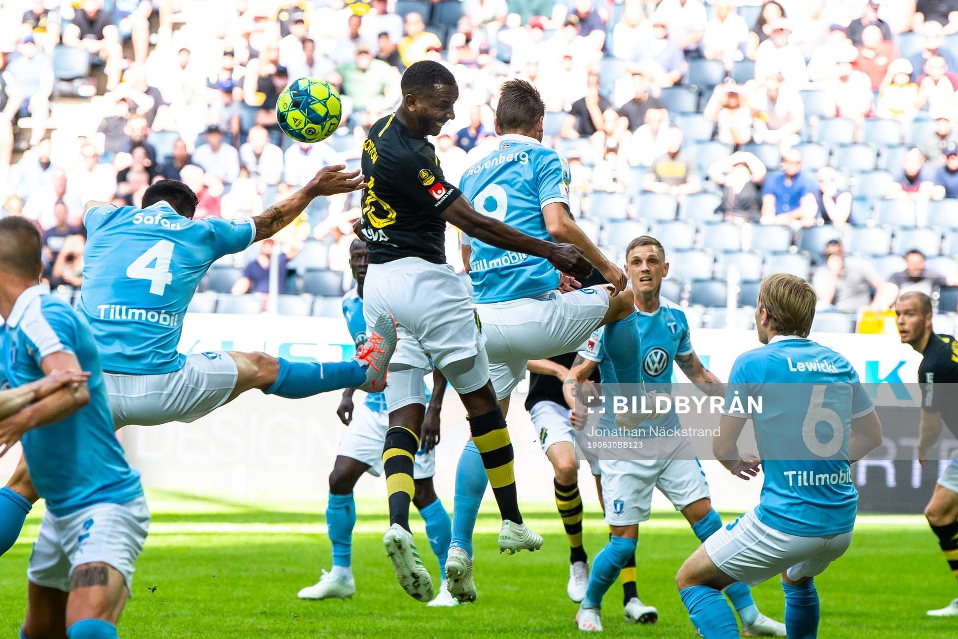 AIK:s Henok Goitom i duell med Malmö FFs Behrang Safari och Markus Rosenberg under fotbollsmatchen i Allsvenskan mellan AIK och Malmö FF den 30 juni 2019 i Stockholm.