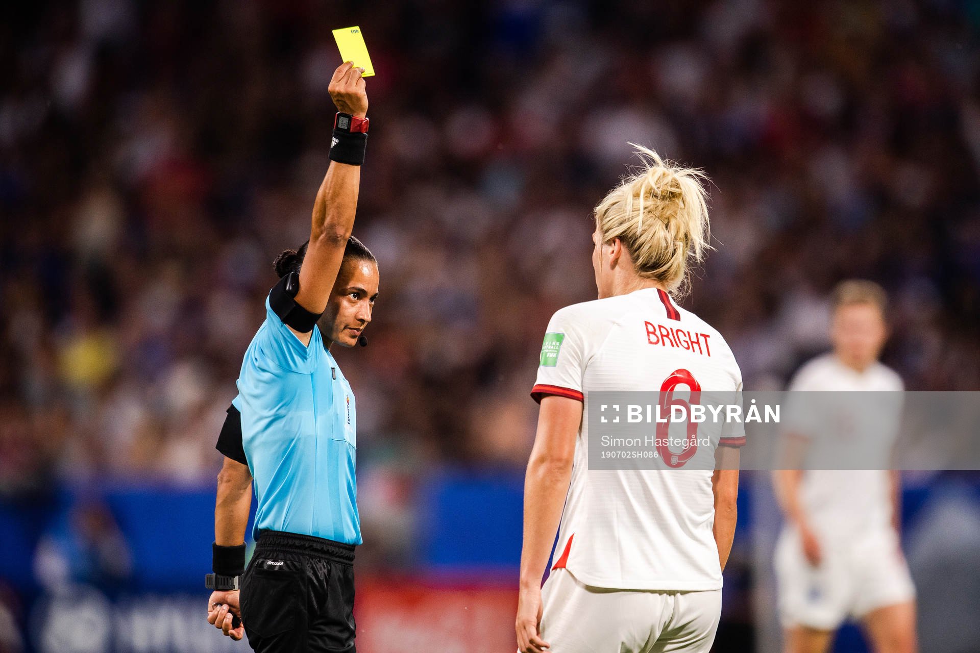 Millie Bright of England receives a yellow card