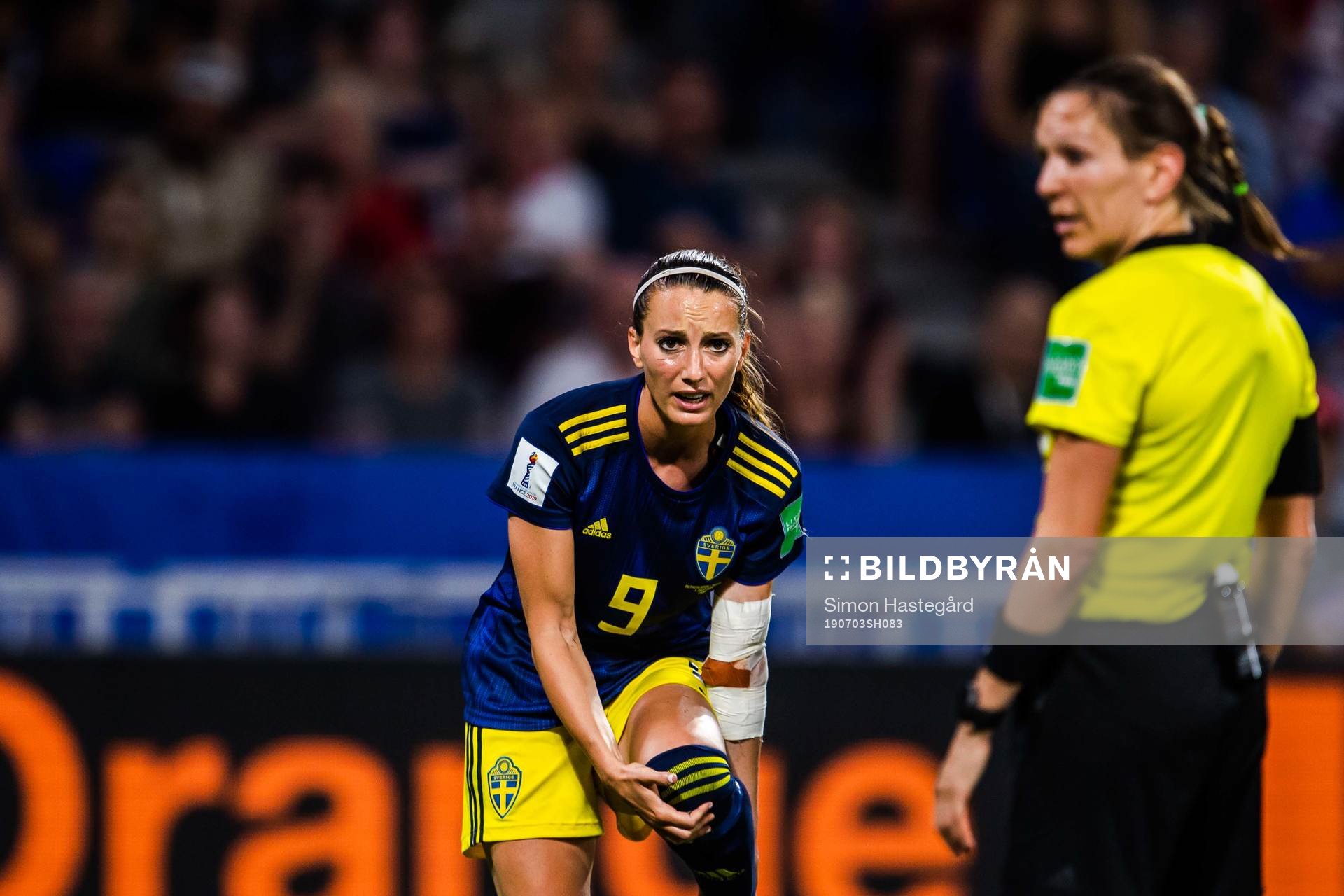 Kosovare Asllani of Sweden and eferee Marie-Soleil Beaudoin
