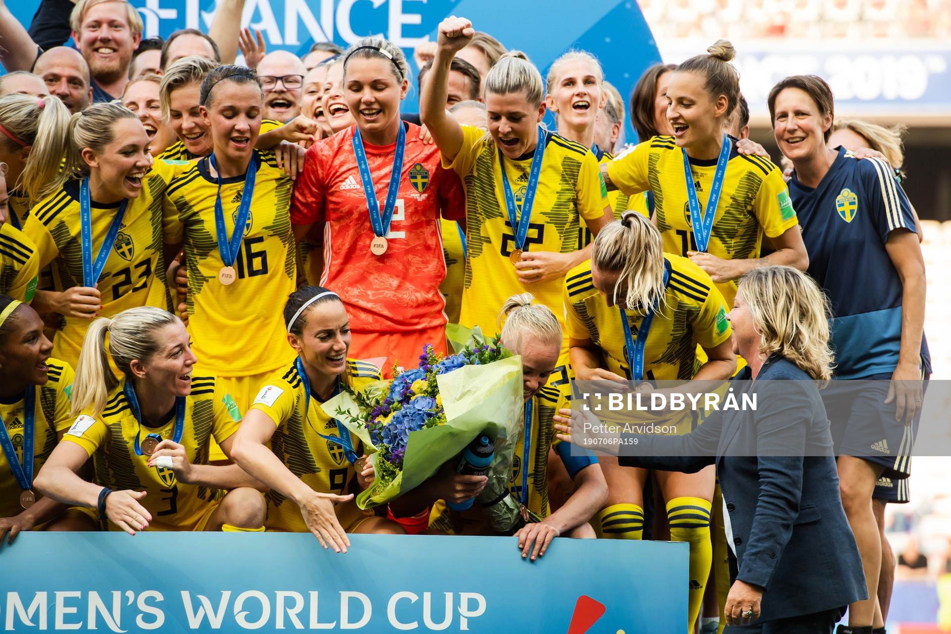 Caroline Seger of Sweden receives flowers for her 200th