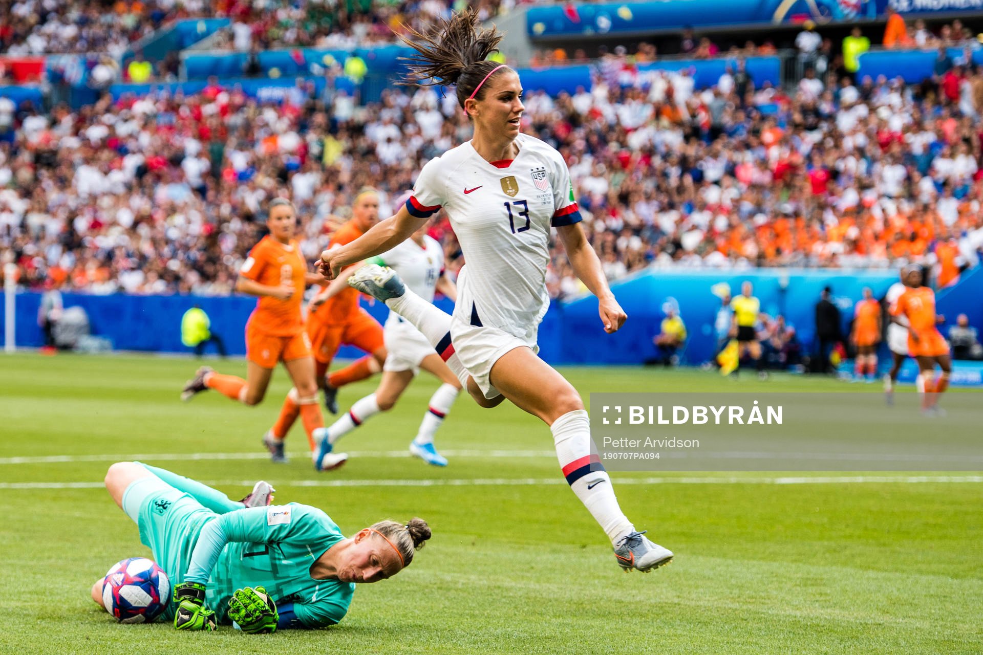 Alex Morgan of USA and goalkeeper Sari Van Veenendaal of