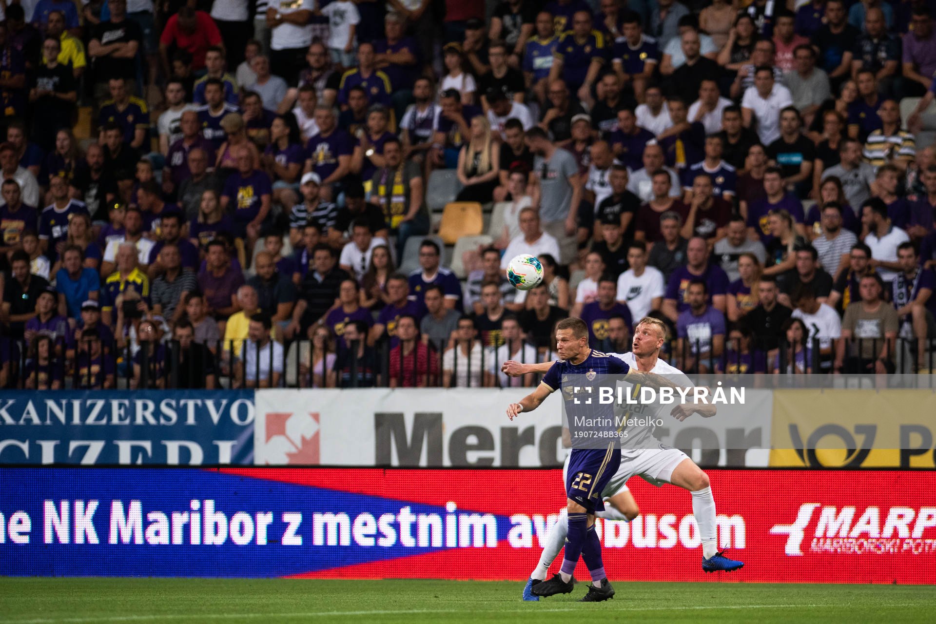 Martin Milec of Maribor compete for the ball with Kolbeinn