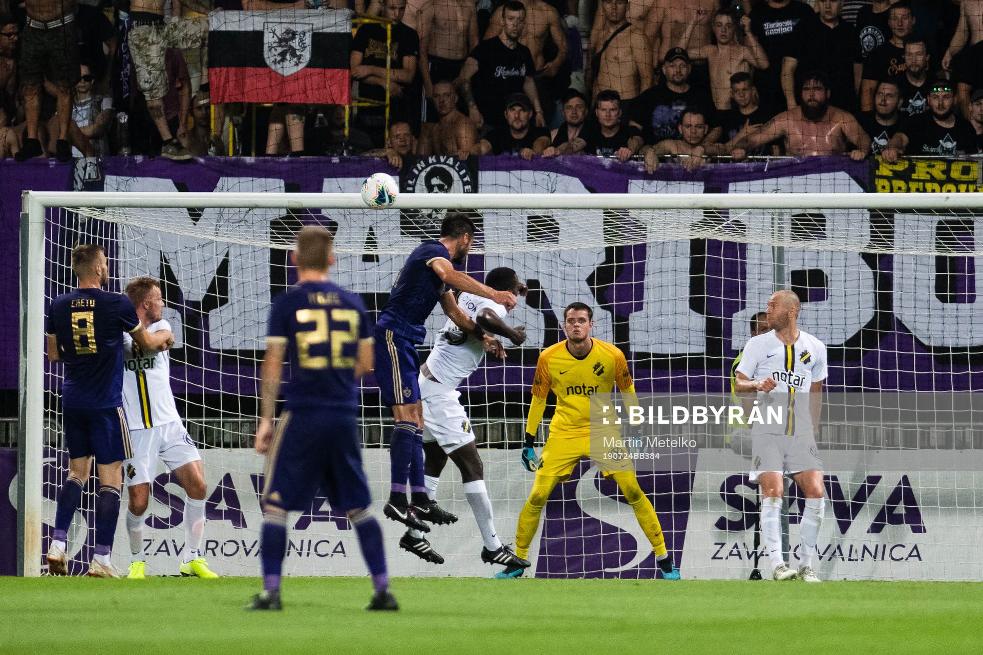 Players compete for the ball in front of goalkeeper Oscar