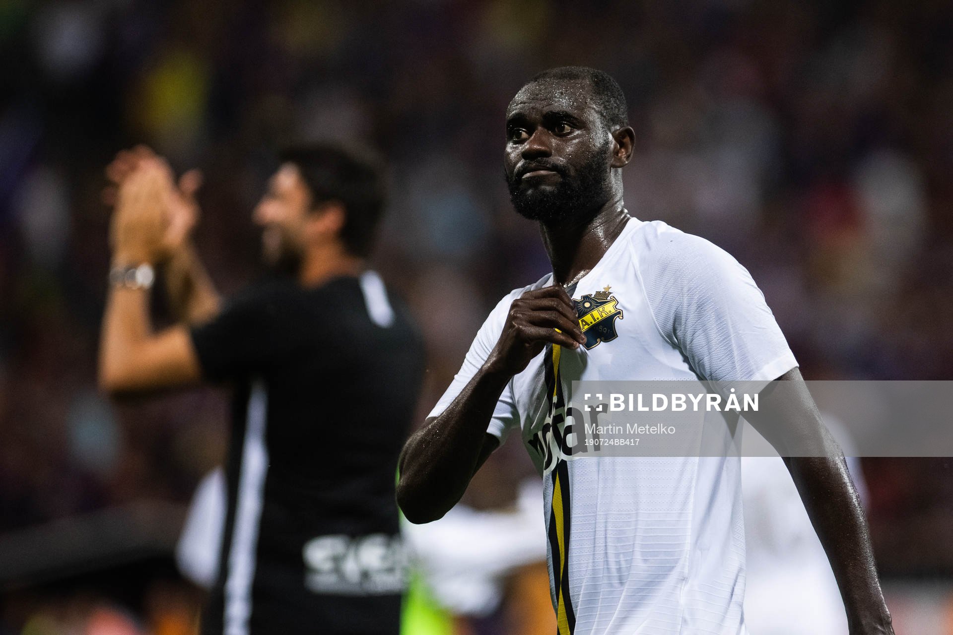 Enoch Kofi Adu of AIK reaches for the club logo while