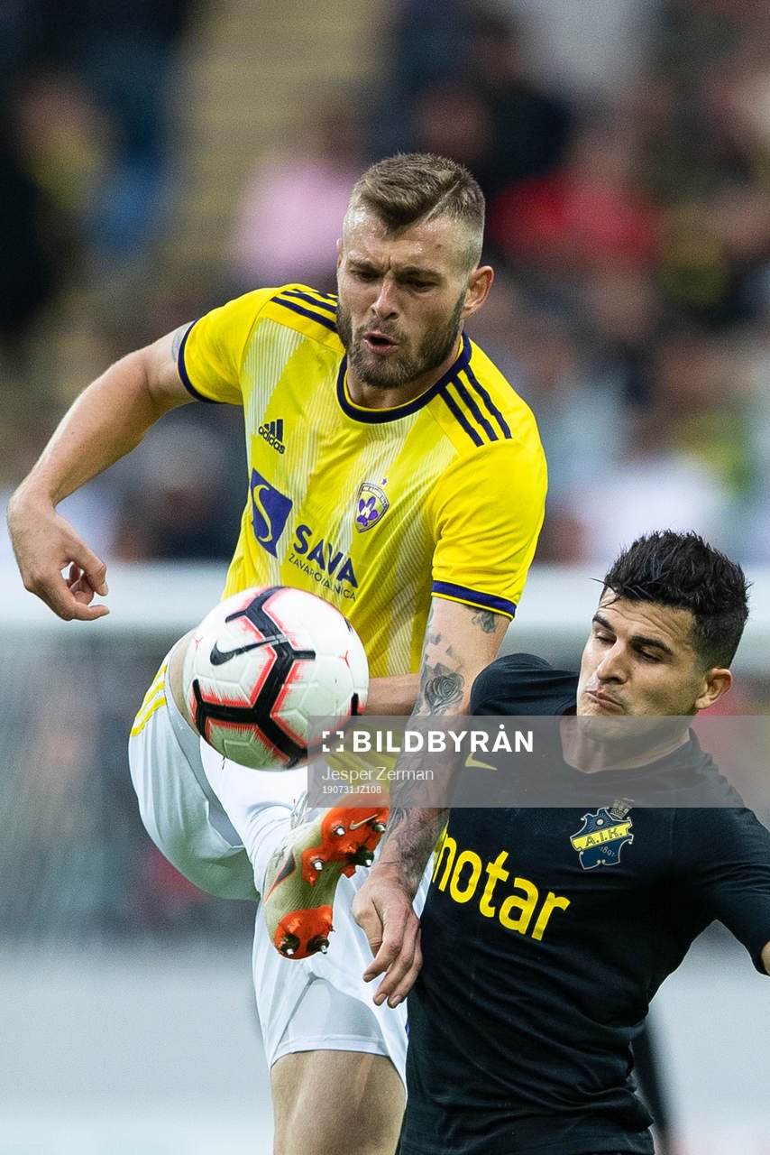 Alexandru Cretu of Maribor and Tarik Elyounoussi of AIK during the UEFA Champions League qualifying match between AIK and Maribor on July 31, 2019 in Stockholm.