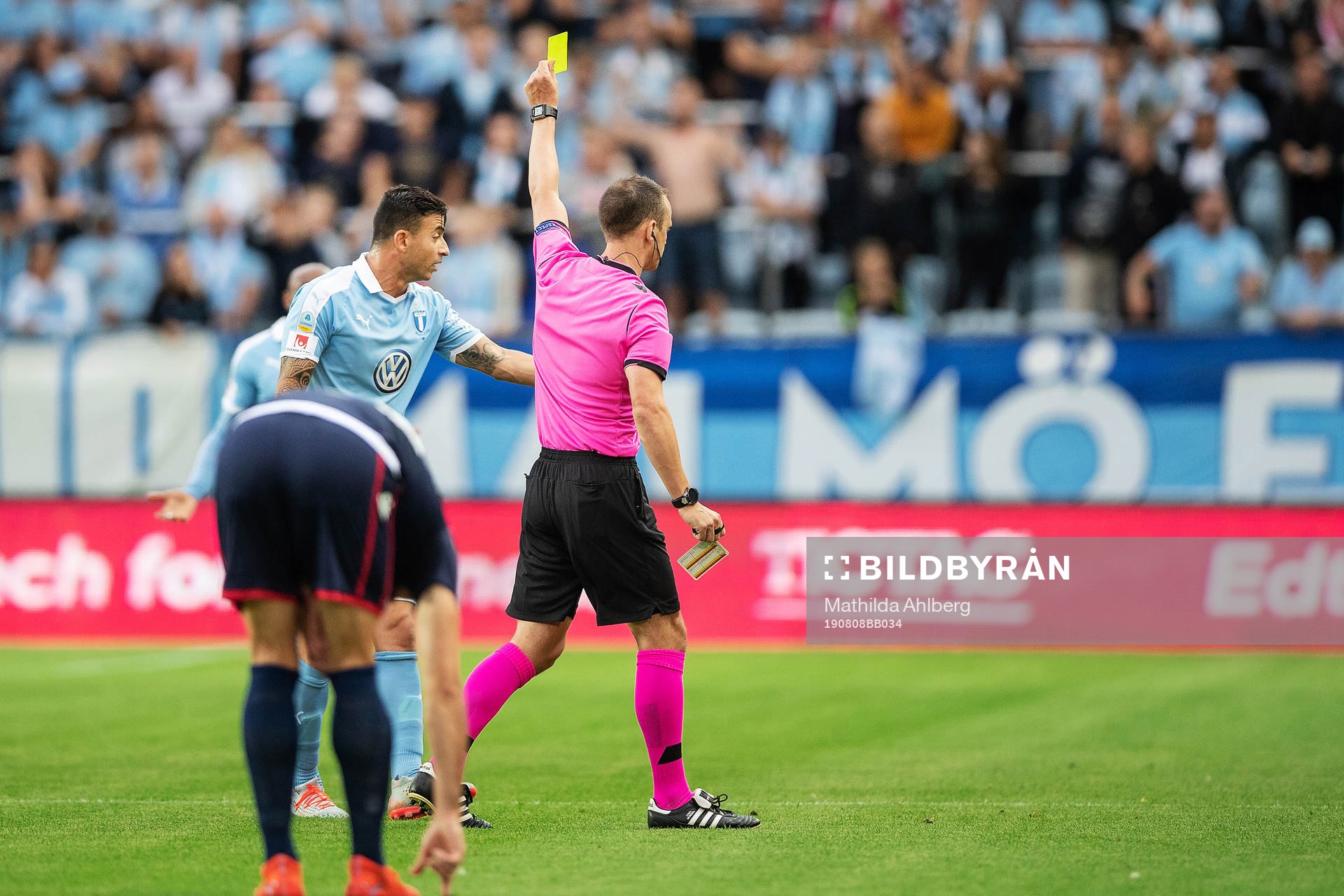 Behrang Safari of Malmö FF is shown a yellow card by