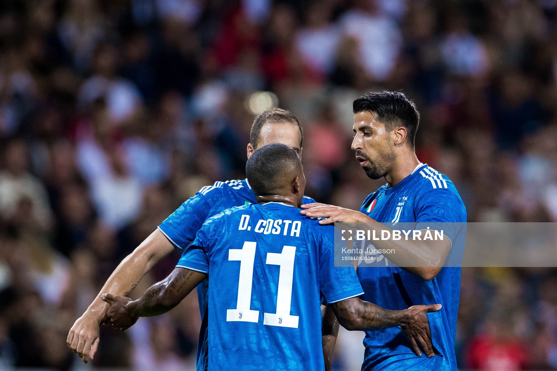 Sami Khedira of Juventus celebrates with Douglas Costa after 1-1 during the International Champions Cup match between Atletico Madrid and Juventus on August 10, 2019 in Stockholm.