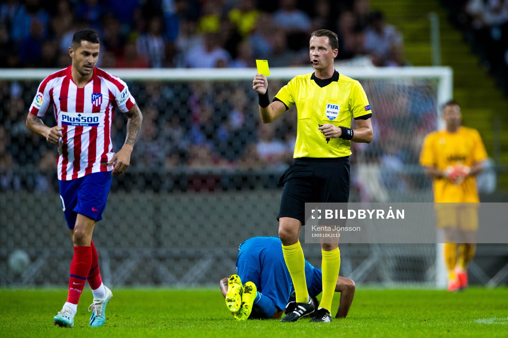 Referee Andreas Ekberg gives a yellow card to Victor Machin