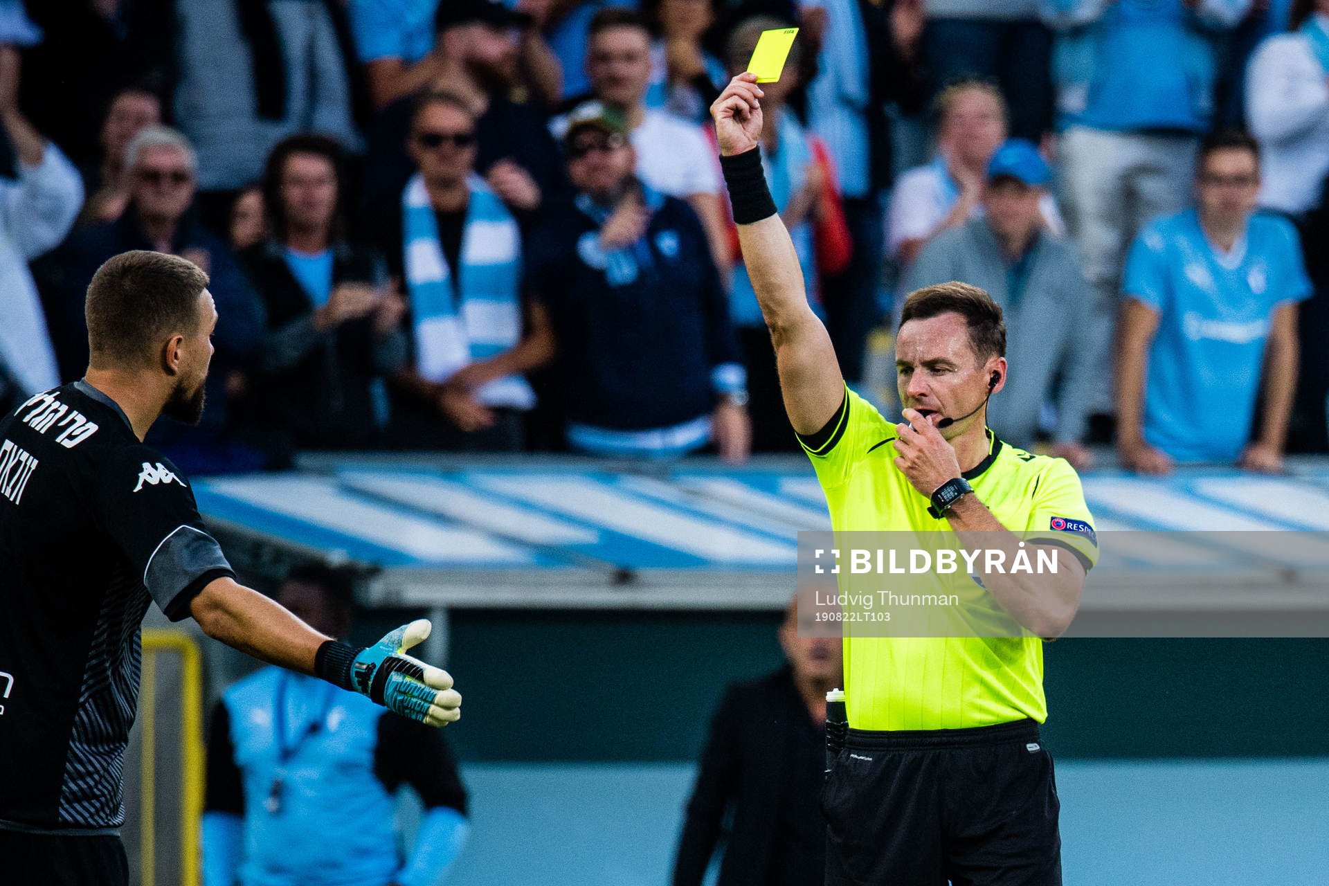 Referee Pawel Raczkowski gives goalkeeper Emilijus Zubas of