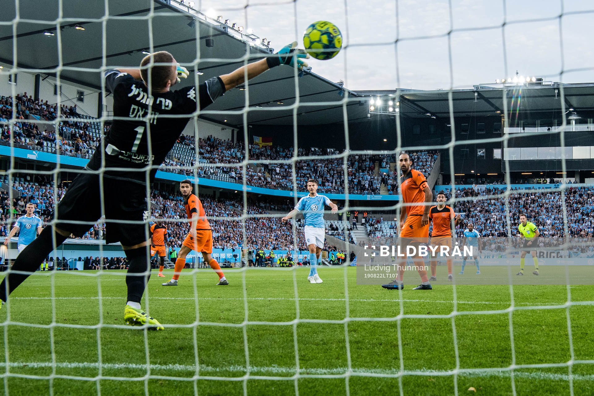 Markus Rosenberg of Malmö FF scores 1-0 behind goalkeeper