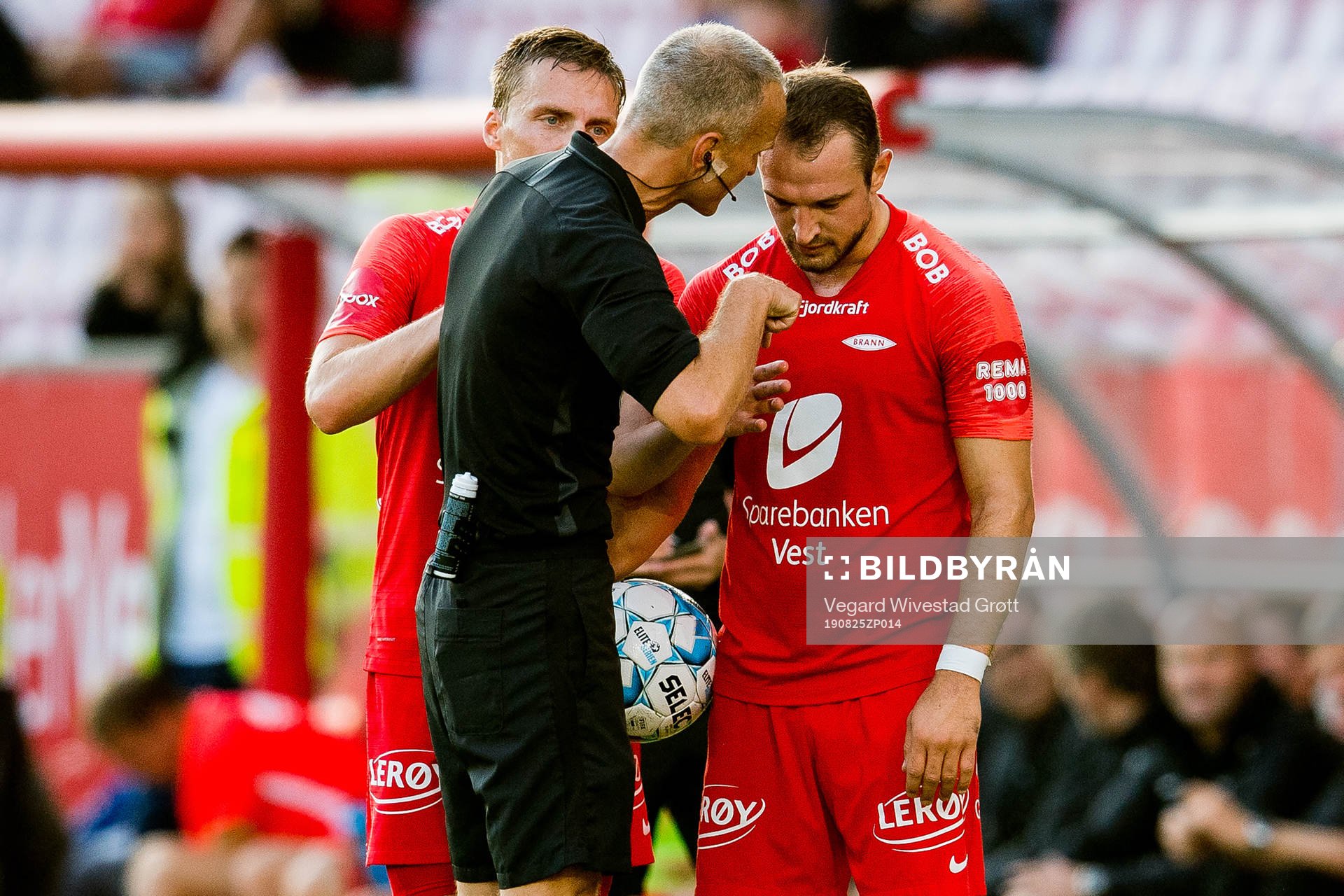Tommy Skjerven, referee, talks to Veton Berisha of Brann
