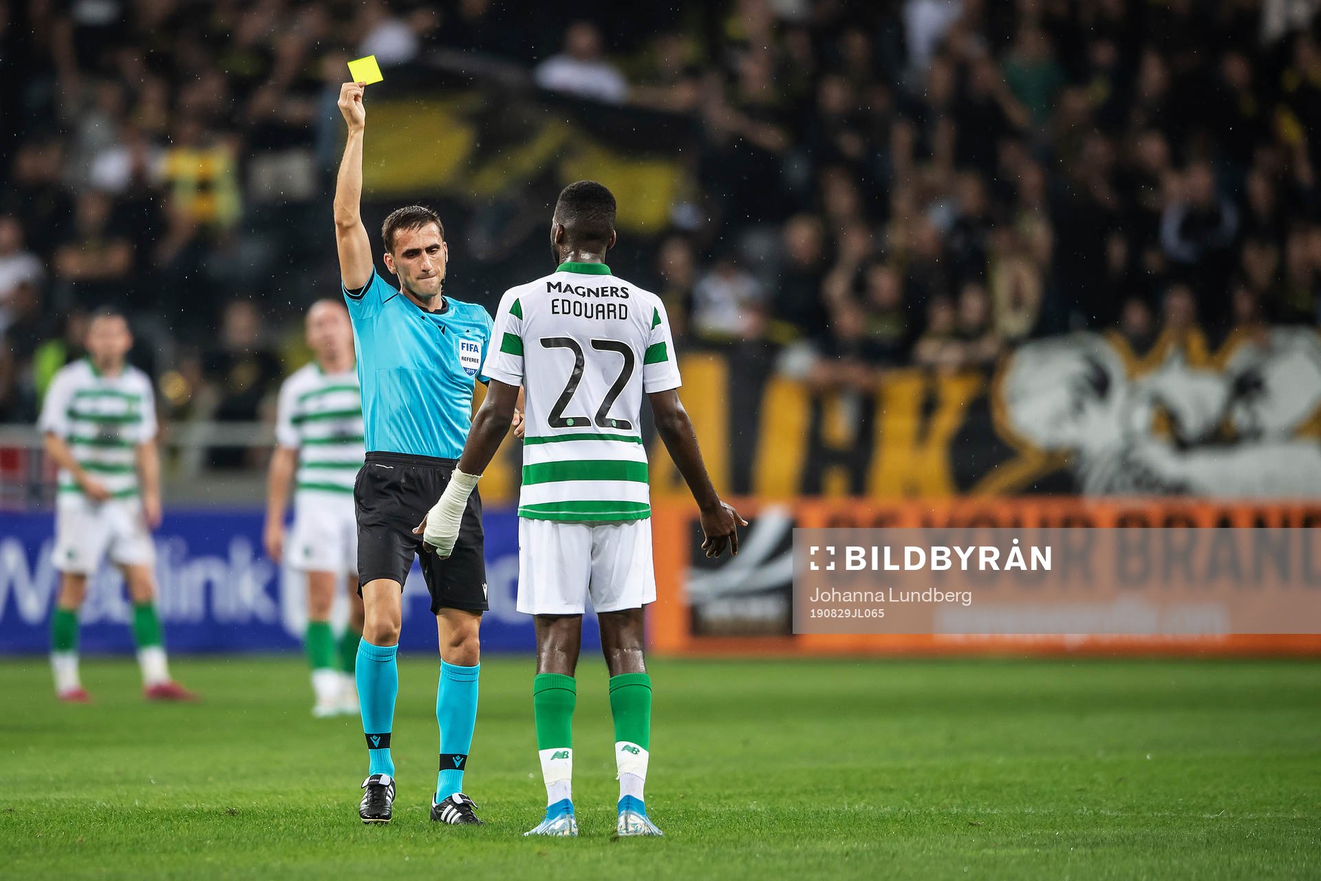 referee Nikola Dabanovic shows a yellow card to Odsonne