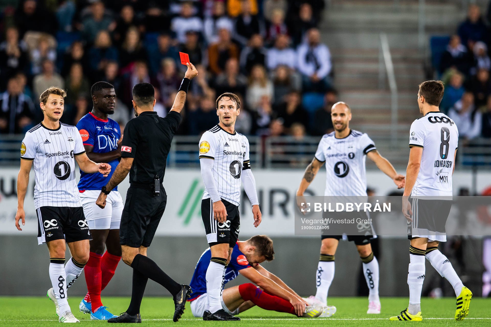 Mike Jensen of Rosenborg is shown a red card from Rohit