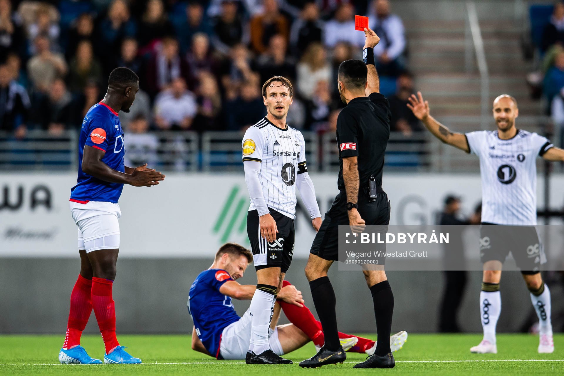 Mike Jensen of Rosenborg is shown a red card from Rohit