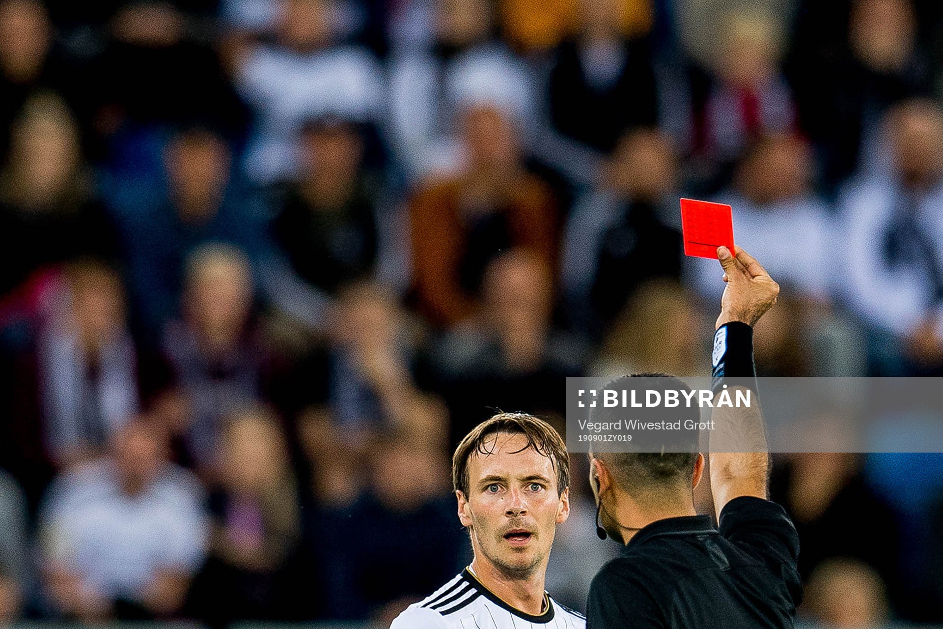 Mike Jensen of Rosenborg receives a red card from referee