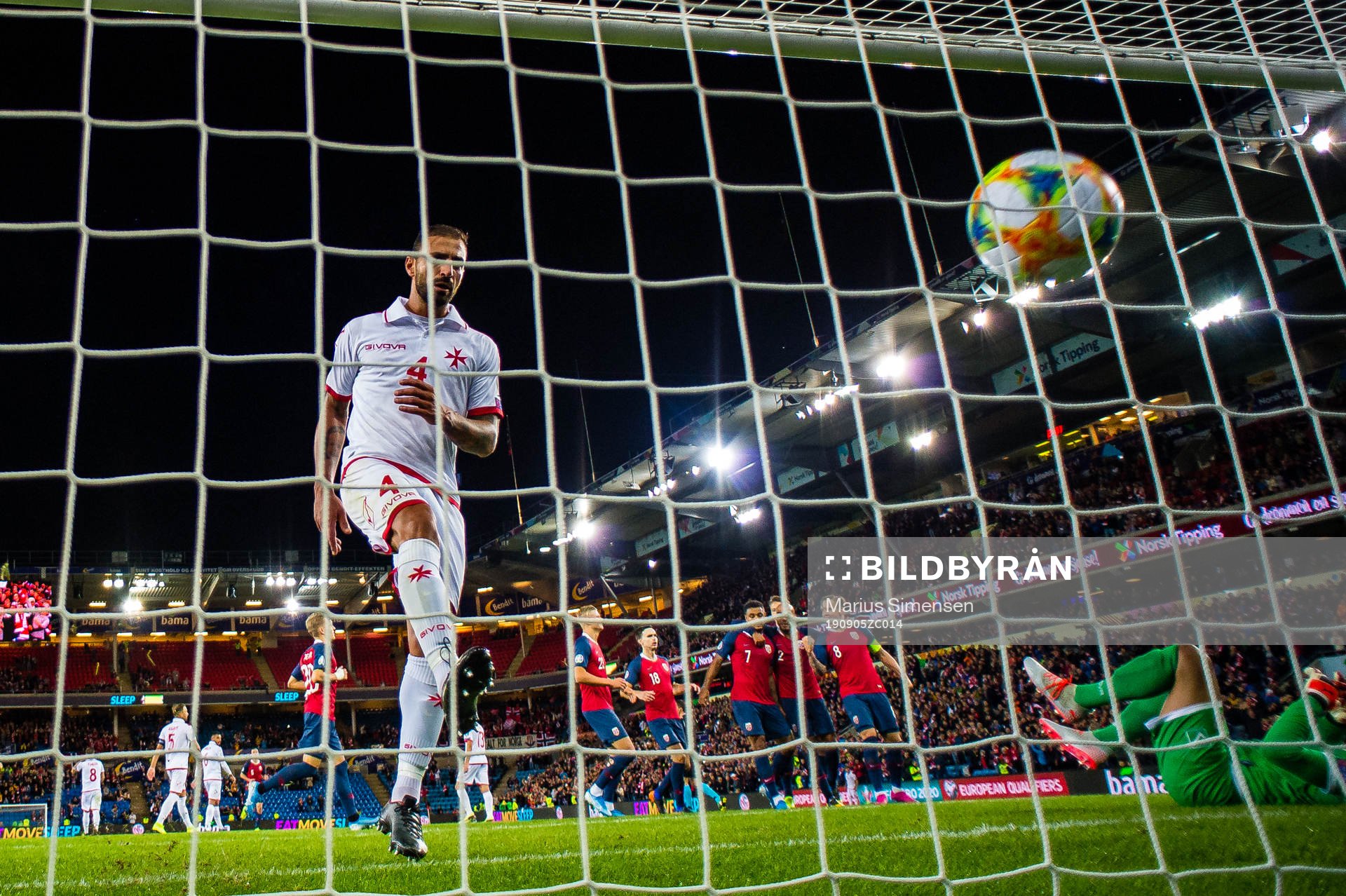 Steve Borg of Malta looks dejected while Joshua King of
