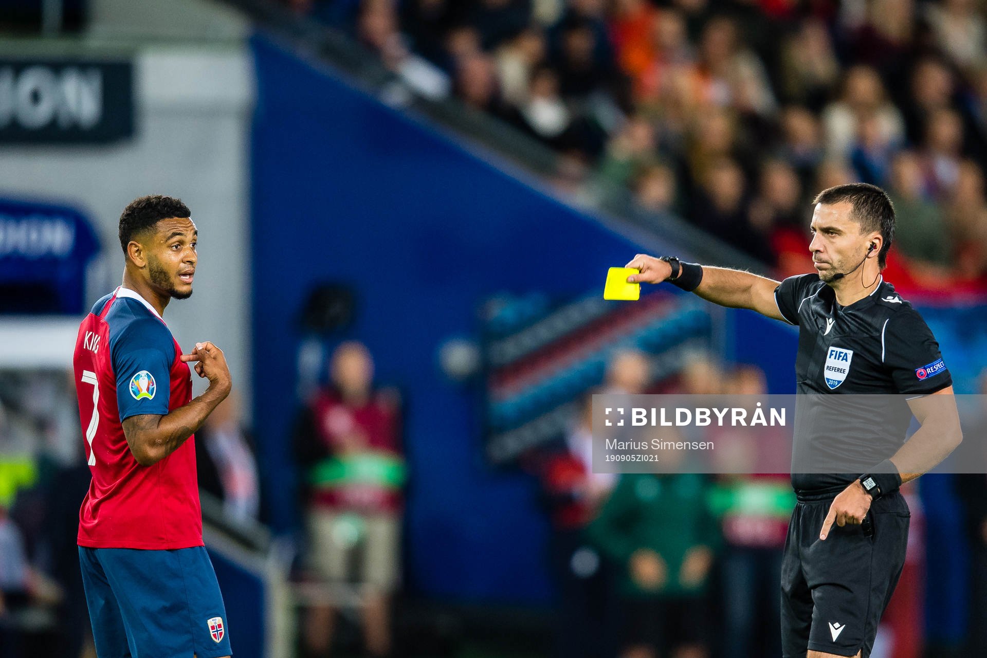 Joshua King of Norway gets a yellow card by Dumitru