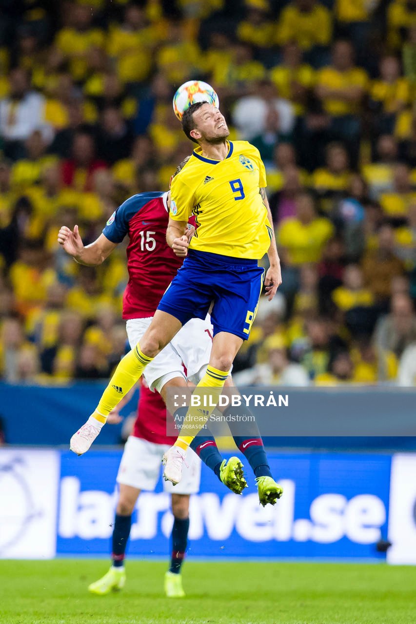 Marcus Berg of Sweden wins a header against Sander Berge of