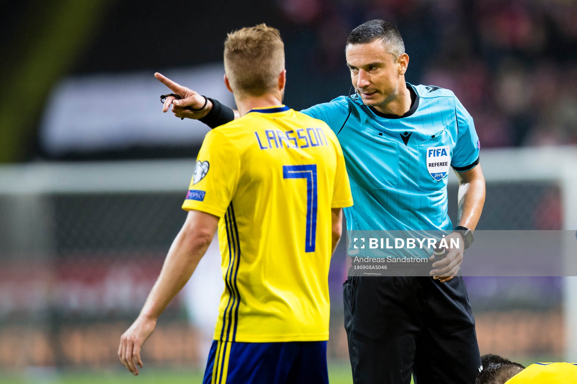 Sebastian Larsson of Sweden have a discussion with referee