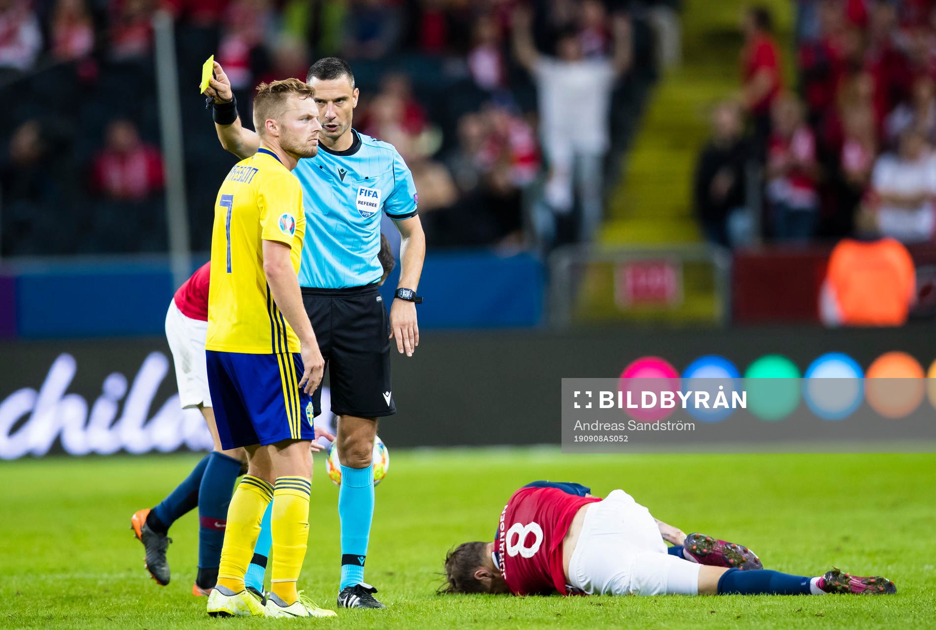 Referee Slavko Vincic with a yellow card to Sebastian